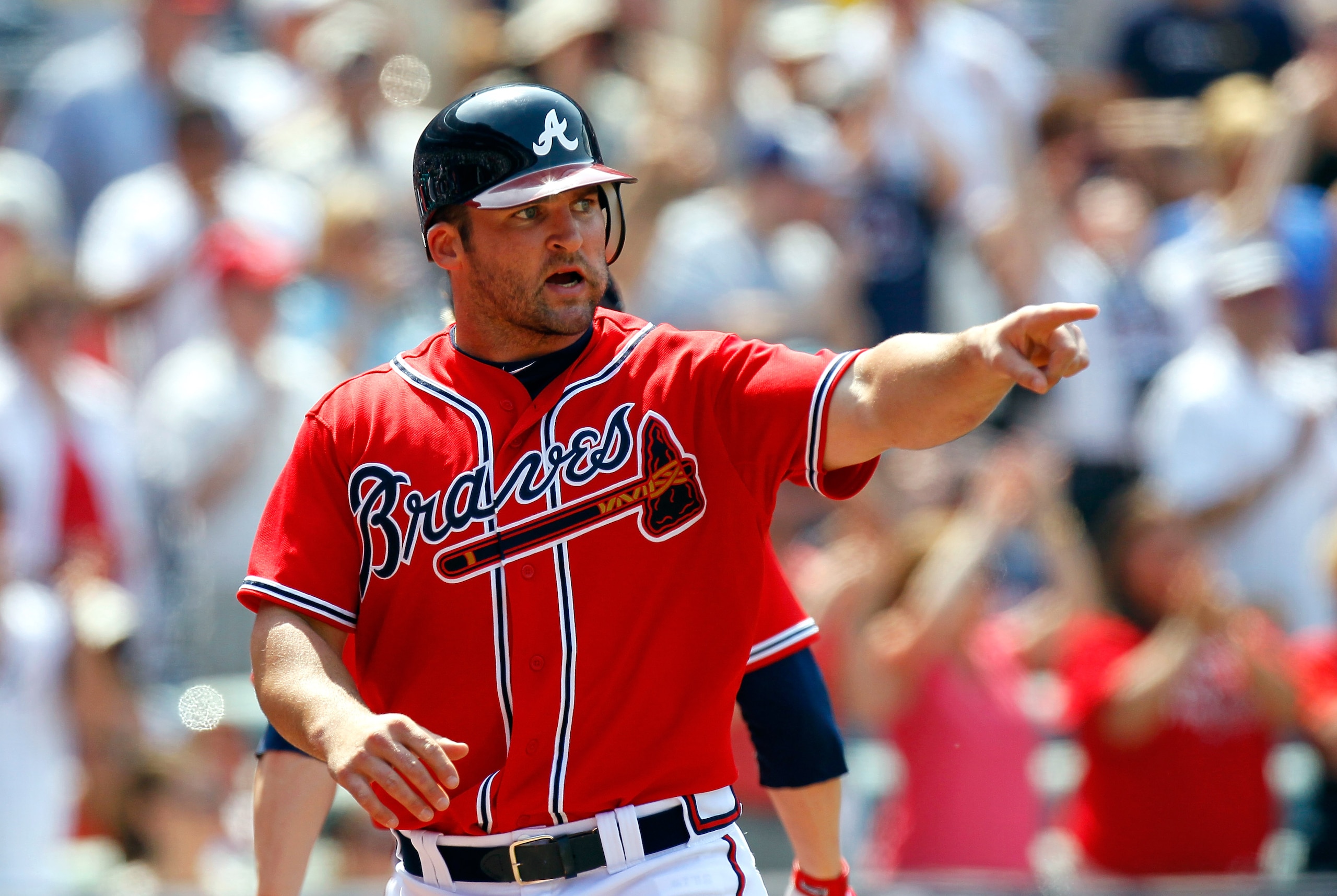 ATLANTA, GA - MAY 01:  Dan Uggla #26 of the Atlanta Braves points to Alex Gonzalez #2 after Uggla scored off Gonzalez's base hit in the seventh against the St. Louis Cardinals at Turner Field on May 1, 2011 in Atlanta, Georgia.  (Photo by Kevin C. Cox/Get