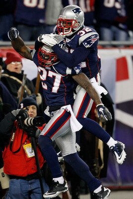 FOXBORO, MA - DECEMBER 19:  Cornerback Kyle Arrington #27 of the New England Patriots (R) is congratulated for scoring a touchdown after intercepting the ball and running 36 yards by teammate cornerback Devin McCourty #32 during the third quarter of the g