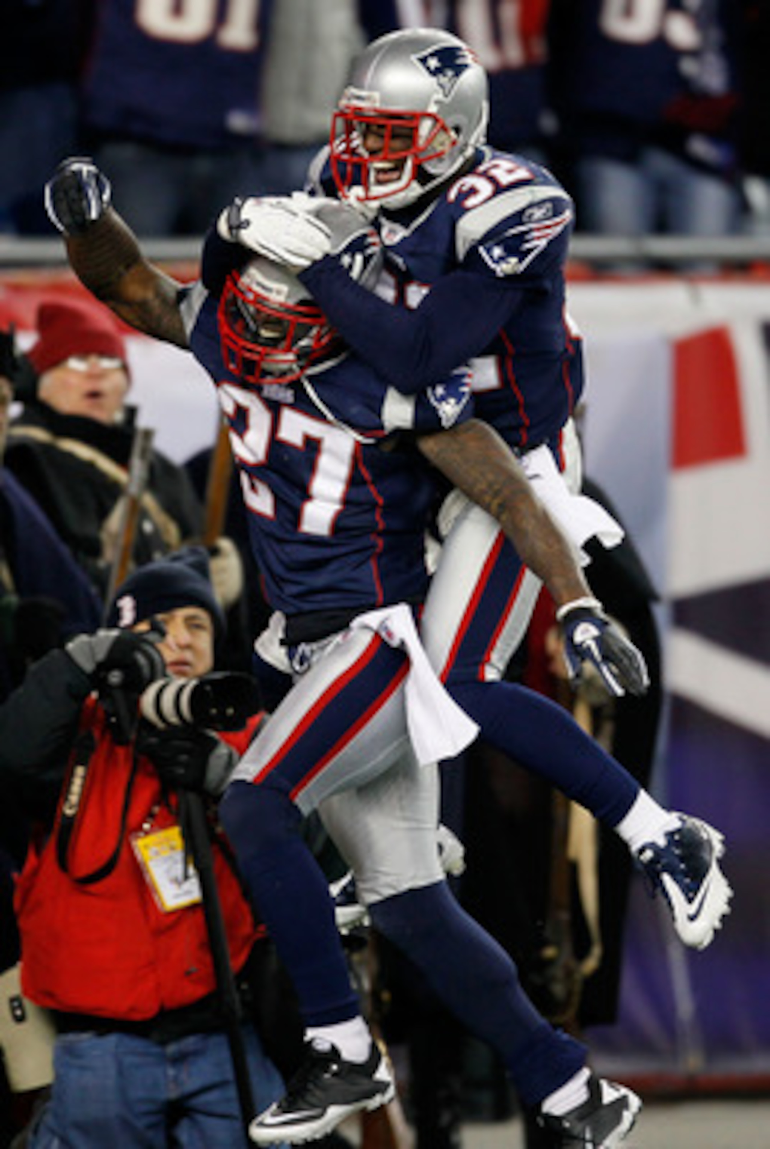 FOXBORO, MA - DECEMBER 19:  Cornerback Kyle Arrington #27 of the New England Patriots (R) is congratulated for scoring a touchdown after intercepting the ball and running 36 yards by teammate cornerback Devin McCourty #32 during the third quarter of the g