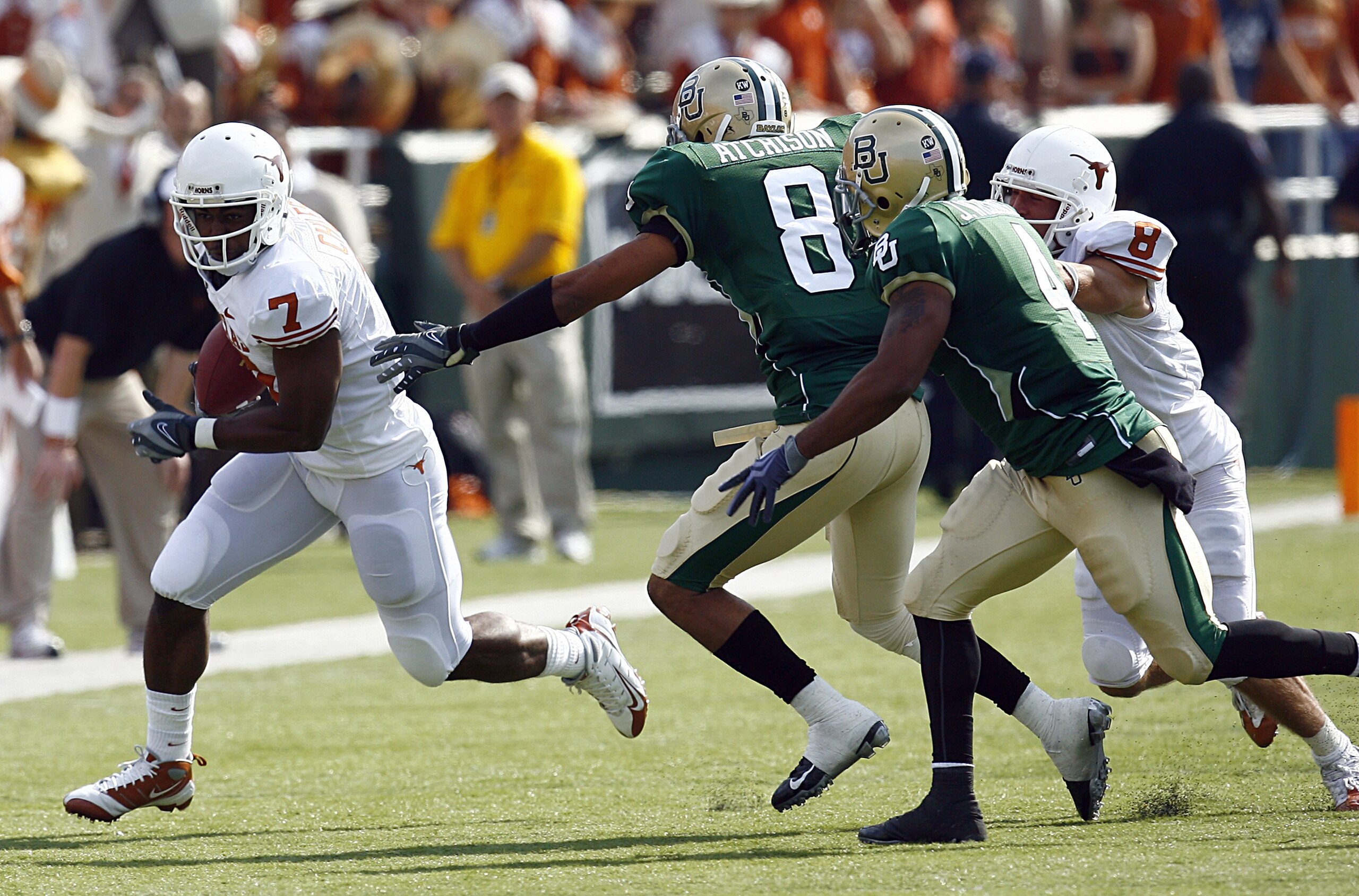 WACO, TX - NOVEMBER 14:  Wide receiver John Chiles #7 of the Texas Longhorns carries the ball during the second half against corner back Tim Atchison #8 and linebacker Jeremy Williams #4 of the Baylor Bears on November 14, 2009 at Floyd Casey Stadium in W
