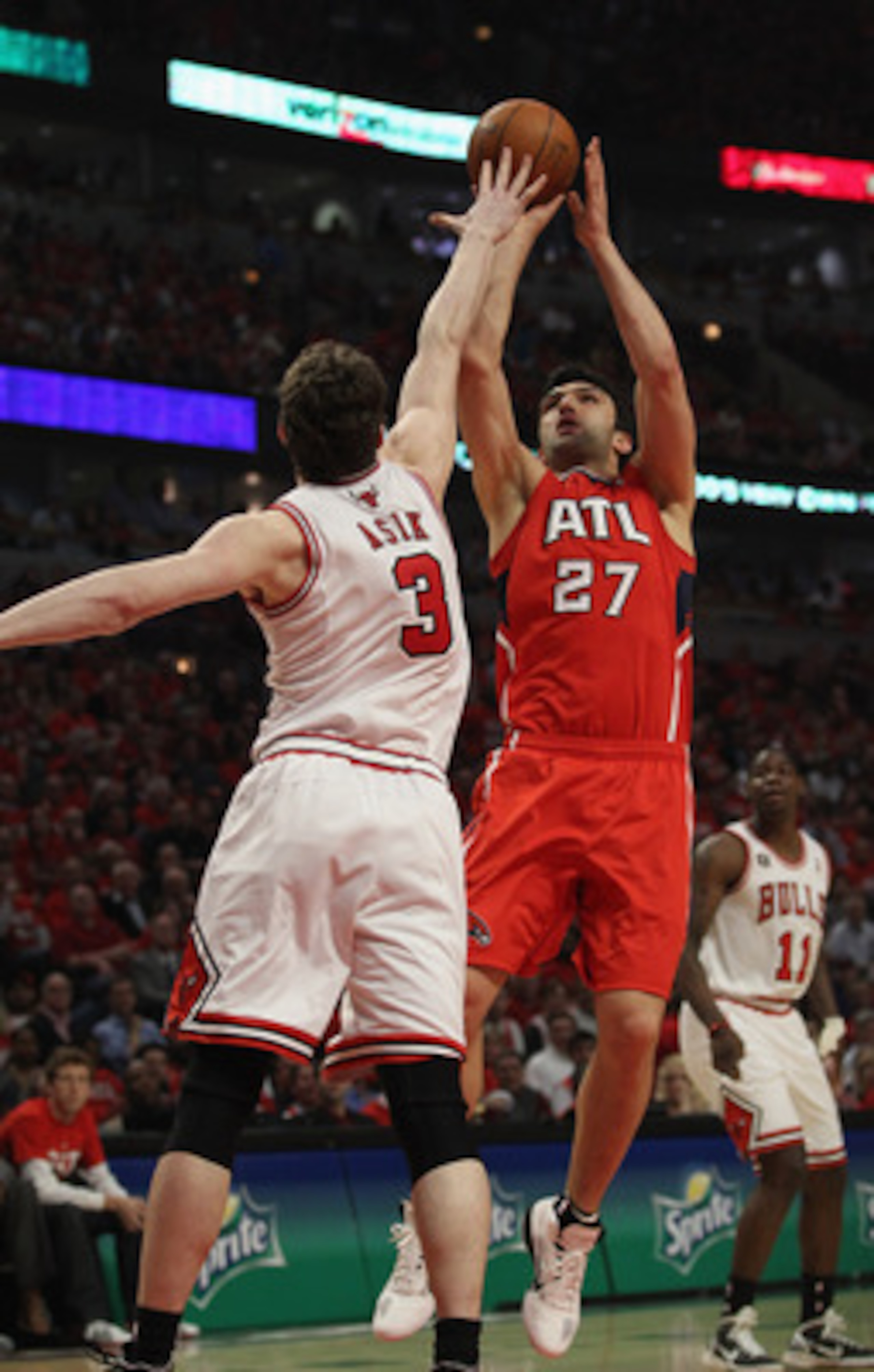 CHICAGO, IL - MAY 10: Zaza Pachulia #27 of the Atlanta Hawks puts up a shot against Omer Asik #3 of the Chicago Bulls in Game Five of the Eastern Conference Semifinals in the 2011 NBA Playoffs at the United Center on May 10, 2011 in Chicago, Illinois. The