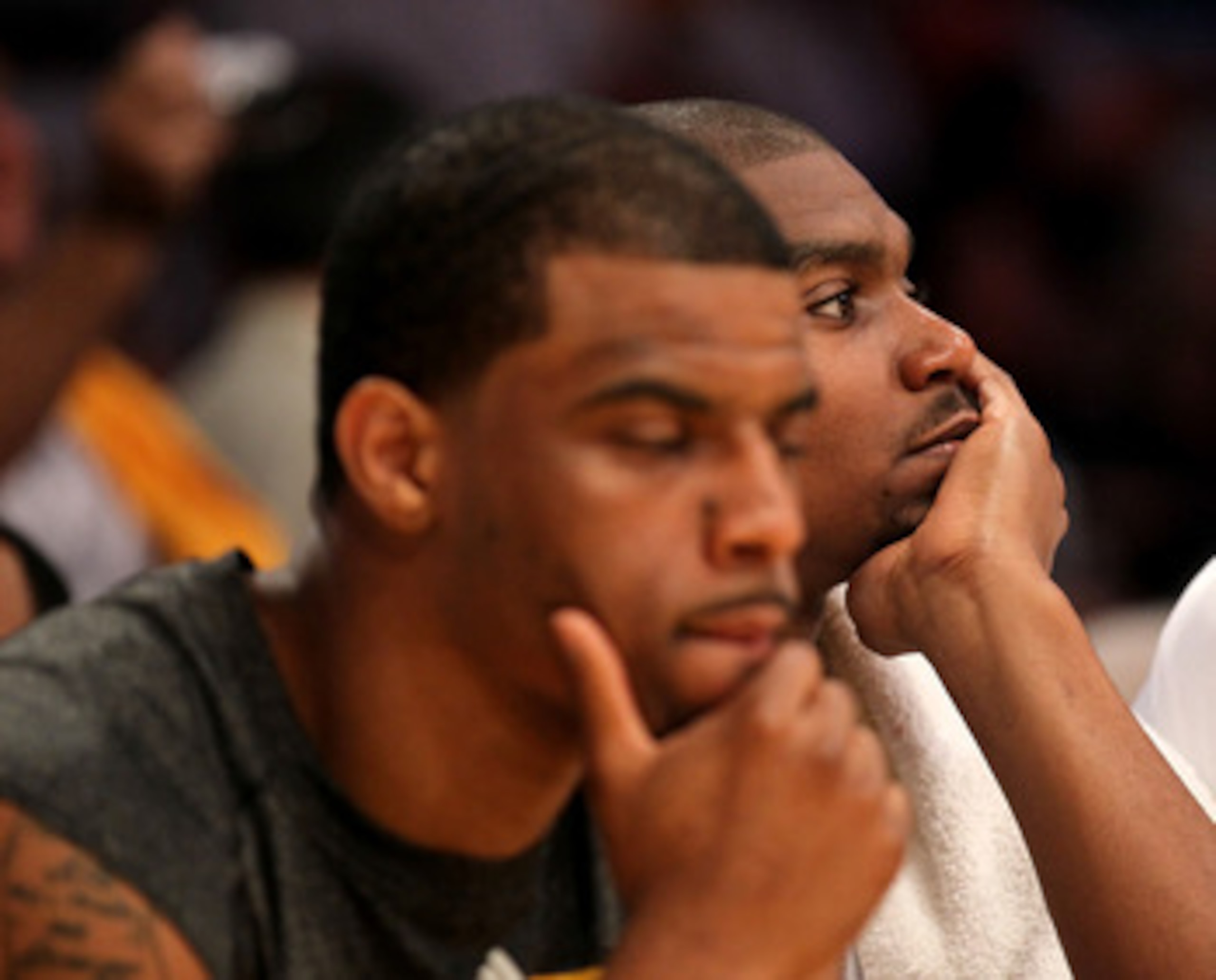 LOS ANGELES, CA - APRIL 17:  Andrew Bynum #17 (R) and Trey Johnson #10 of the Los Angeles Lakers watch the fiinal moments against the New Orleans Hornets in Game One of the Western Conference Quarterfinals in the 2011 NBA Playoffs on April 17, 2011 at Sta