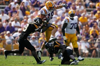 BATON ROUGE, LA - AUGUST 30: Richard Dickson #18 of the Louisiana State University Tigers jumps over Justin Johnson #55 of the Appalachian State Mountaineers on August 30, 2008 at Tiger Stadium in Baton Rouge, Louisiana. (Photo by Chris Graythen/Getty I BATON ROUGE, LA - AUGUST 30: Richard Dickson #18 of the Louisiana State University Tigers jumps over Justin Johnson #55 of the Appalachian State Mountaineers on August 30, 2008 at Tiger Stadium in Baton Rouge, Louisiana. (Photo by Chris Graythen/Getty I