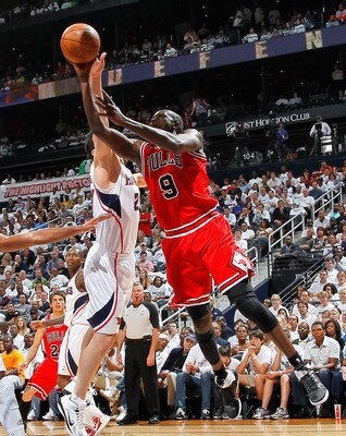 ATLANTA, GA - MAY 12:  Luol Deng #9 of the Chicago Bulls shoots against Zaza Pachulia #27 of the Atlanta Hawks in Game Six of the Eastern Conference Semifinals in the 2011 NBA Playoffs at Phillips Arena on May 12, 2011 in Atlanta, Georgia.  NOTE TO USER: 