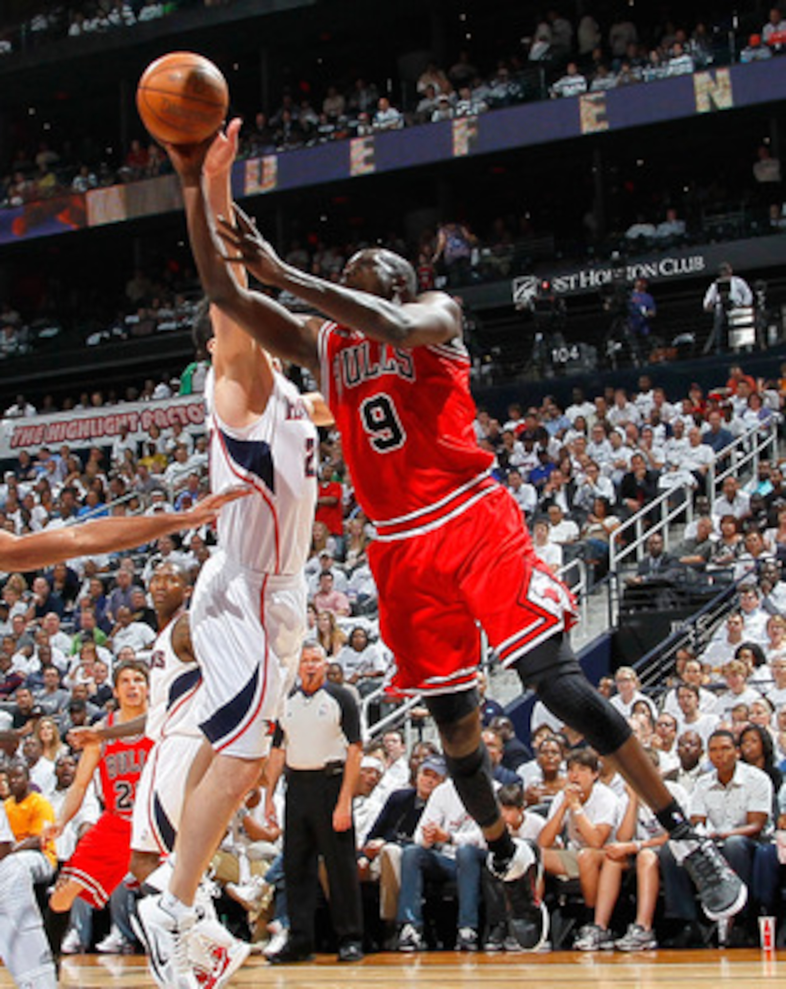ATLANTA, GA - MAY 12:  Luol Deng #9 of the Chicago Bulls shoots against Zaza Pachulia #27 of the Atlanta Hawks in Game Six of the Eastern Conference Semifinals in the 2011 NBA Playoffs at Phillips Arena on May 12, 2011 in Atlanta, Georgia.  NOTE TO USER: 