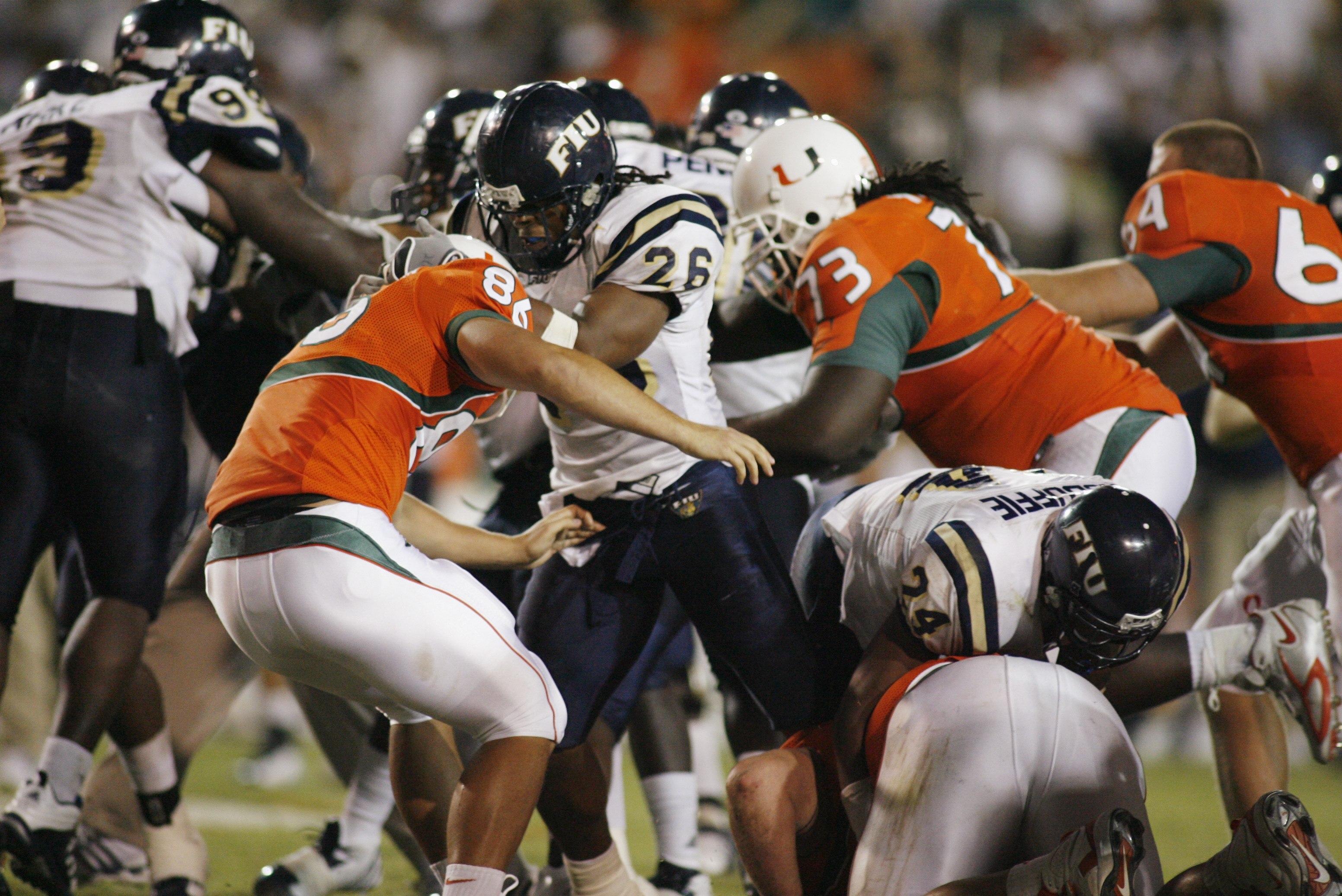 MIAMI - OCTOBER 14:  Chris Smith #26 of the Florida International Panthers fights Ross Abramson #86 of the Miami Hurricanes during an on field fight at the Orange Bowl on October 14, 2006 in Miami, Florida. Miami won 35-0.  (Photo by Marc Serota/Getty Ima