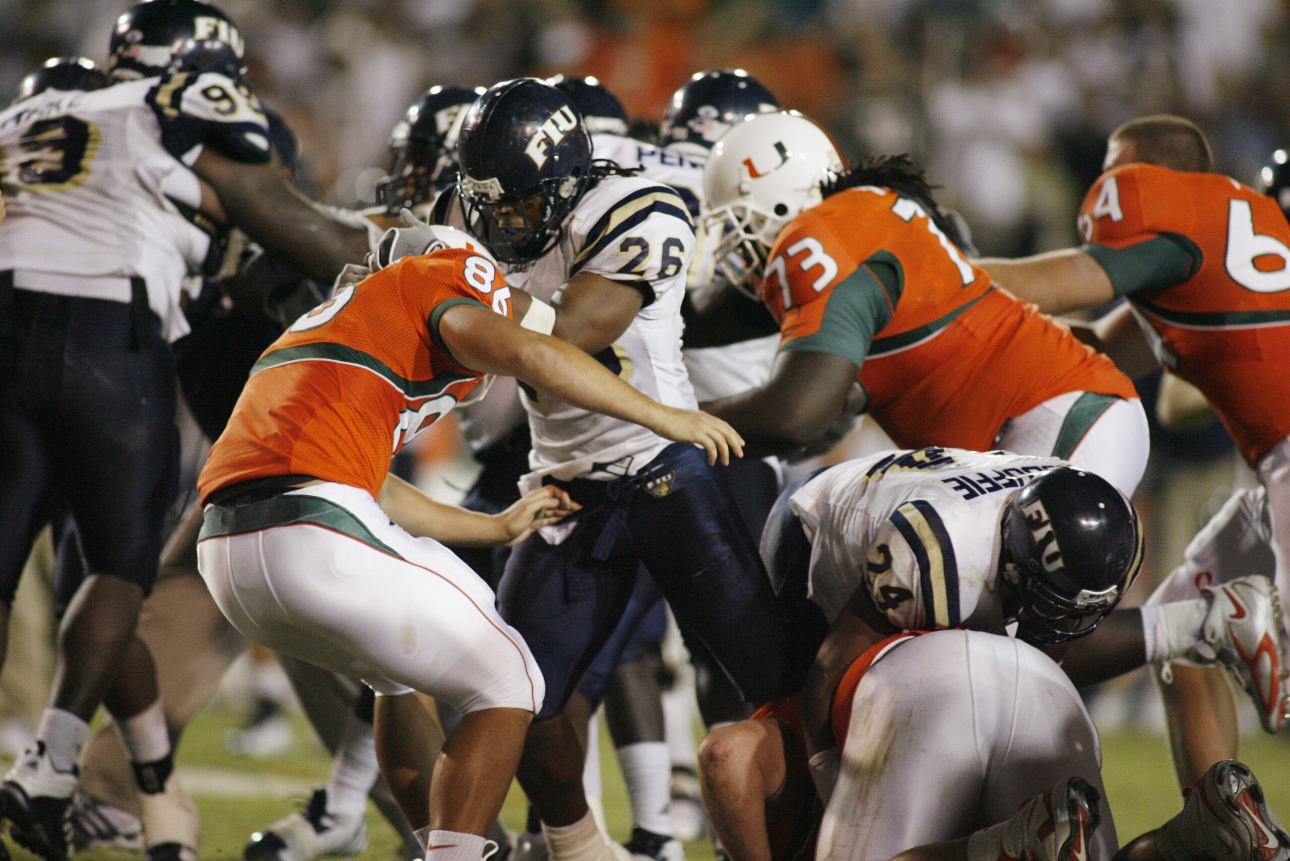 MIAMI - OCTOBER 14:  Chris Smith #26 of the Florida International Panthers fights Ross Abramson #86 of the Miami Hurricanes during an on field fight at the Orange Bowl on October 14, 2006 in Miami, Florida. Miami won 35-0.  (Photo by Marc Serota/Getty Ima