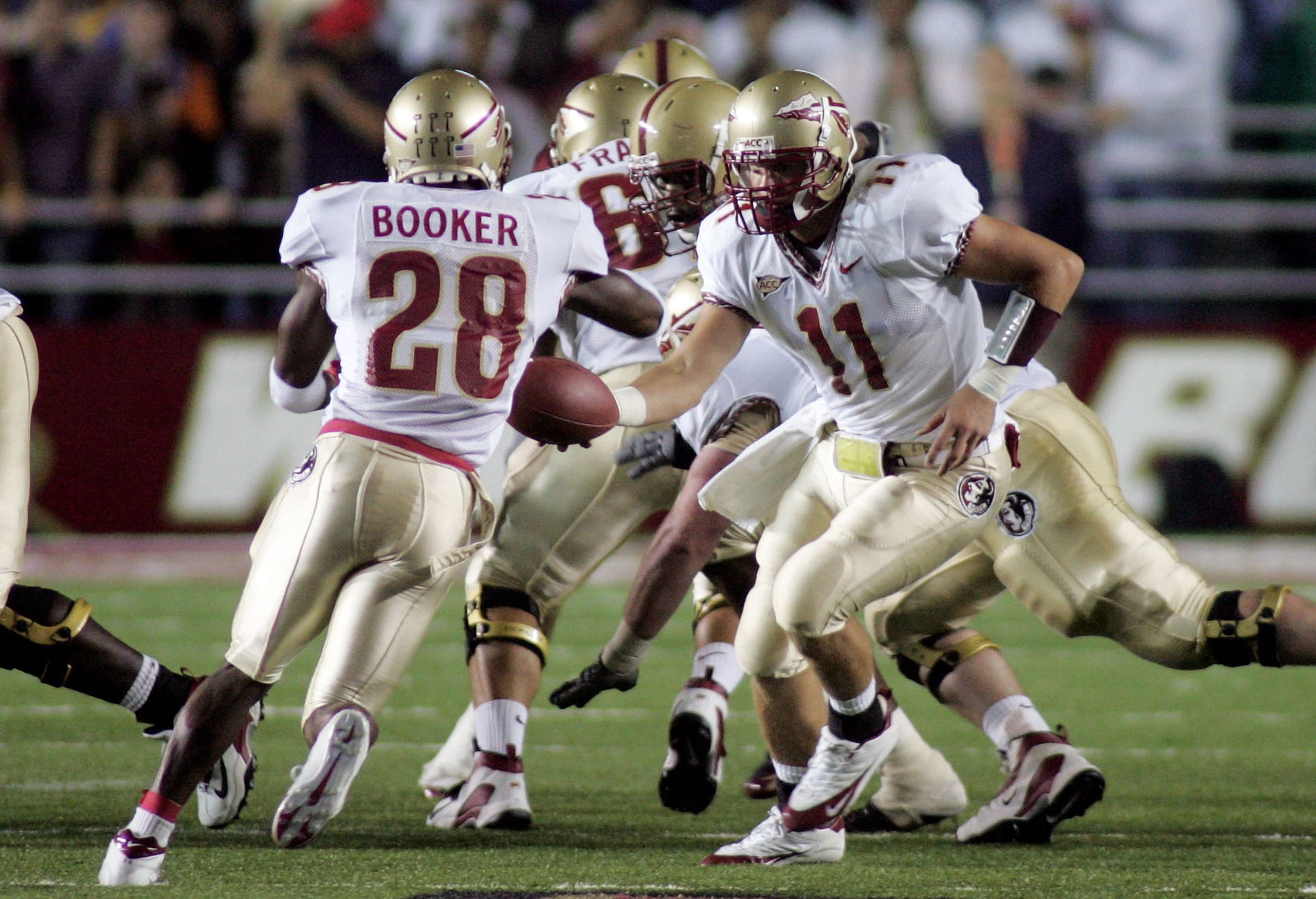 CHESTNUT HILL, MA - SEPTEMBER 17:  Quarterback Drew Weatherford #11 of the Florida State Seminoles hands the ball off to teammate runningback Lorenzo Booker #28 during their Atlantic Coast Conference game against the Boston College Eagles at Alumi Stadium
