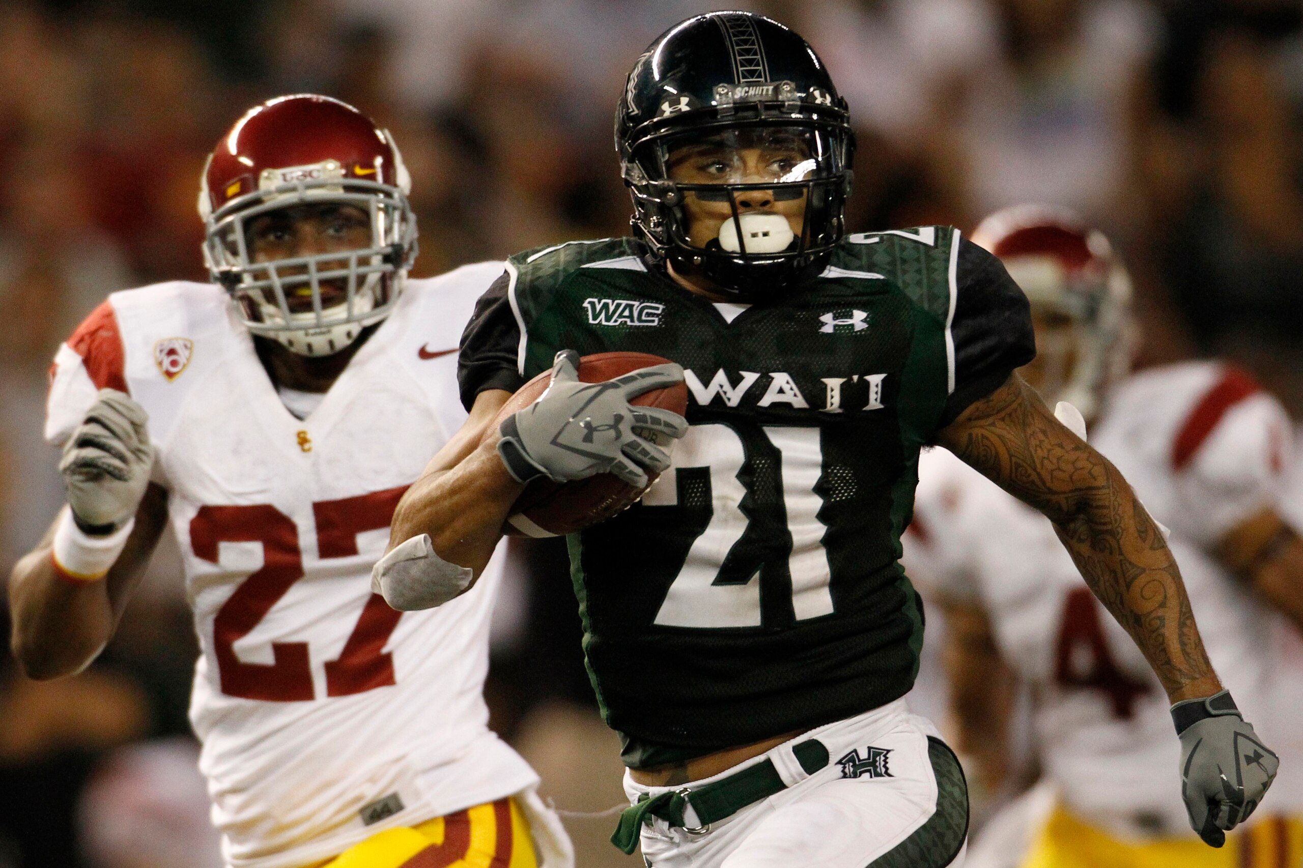 HONOLULU - SEPTEMBER 02: Kealoha Pilares #21 of the University of Hawaii Warriors carries the ball during second half action second half action at Aloha Stadium September 2, 2010 in Honolulu, Hawaii. (Photo by Kent Nishimura/Getty Images)