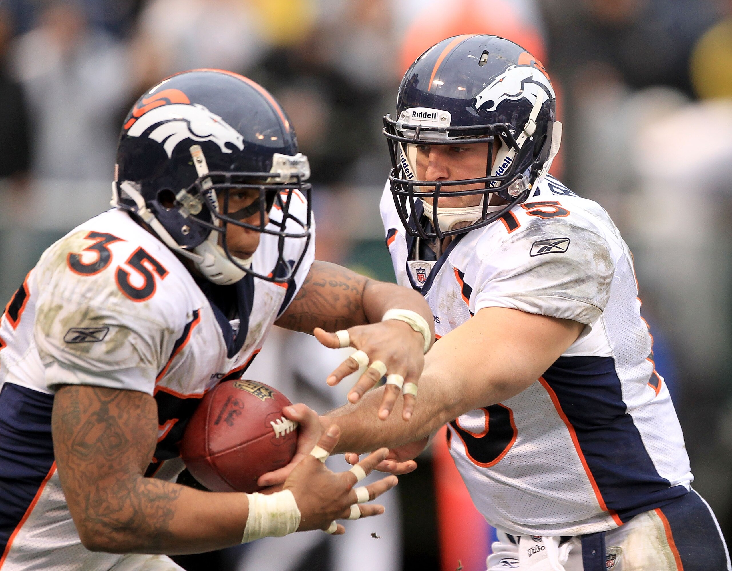 OAKLAND, CA - DECEMBER 19: Tim Tebow #15 of the Denver Broncos hands off to Lance Ball #35 during their game against the Oakland Raiders at Oakland-Alameda County Coliseum on December 19, 2010 in Oakland, California. (Photo by Ezra Shaw/Getty Images) OAKLAND, CA - DECEMBER 19: Tim Tebow #15 of the Denver Broncos hands off to Lance Ball #35 during their game against the Oakland Raiders at Oakland-Alameda County Coliseum on December 19, 2010 in Oakland, California. (Photo by Ezra Shaw/Getty Images)