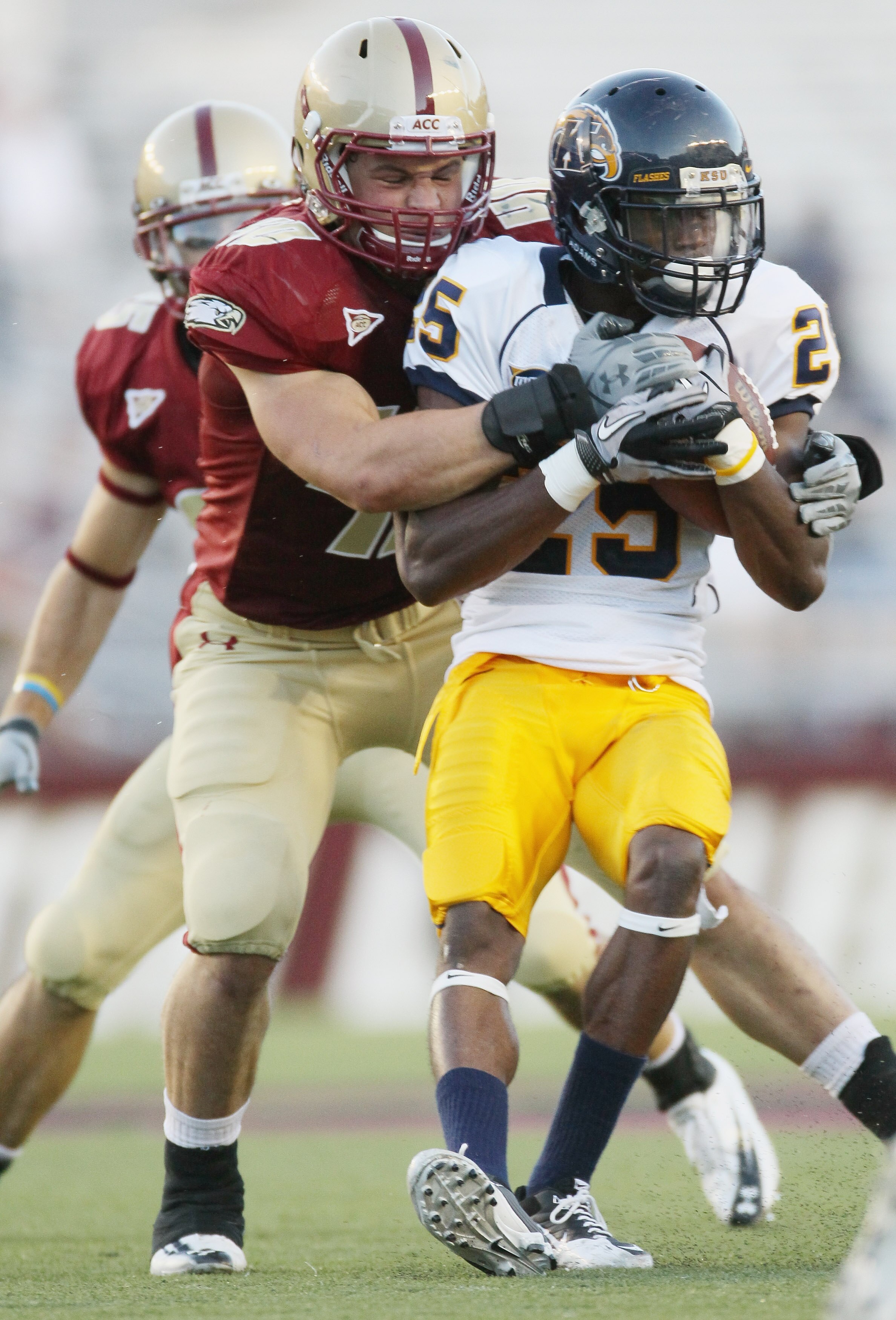 CHESTNUT HILL, MA - SEPTEMBER 11:  Anthony Bowman Jr #25 of the Kent State Golden Flashes is tackled by Ryan Quigley #46 of the Boston College Eagles on September 11, 2010 at Alumni Stadium in Chestnut Hill, Massachusetts. Boston College defeated Kent Sta