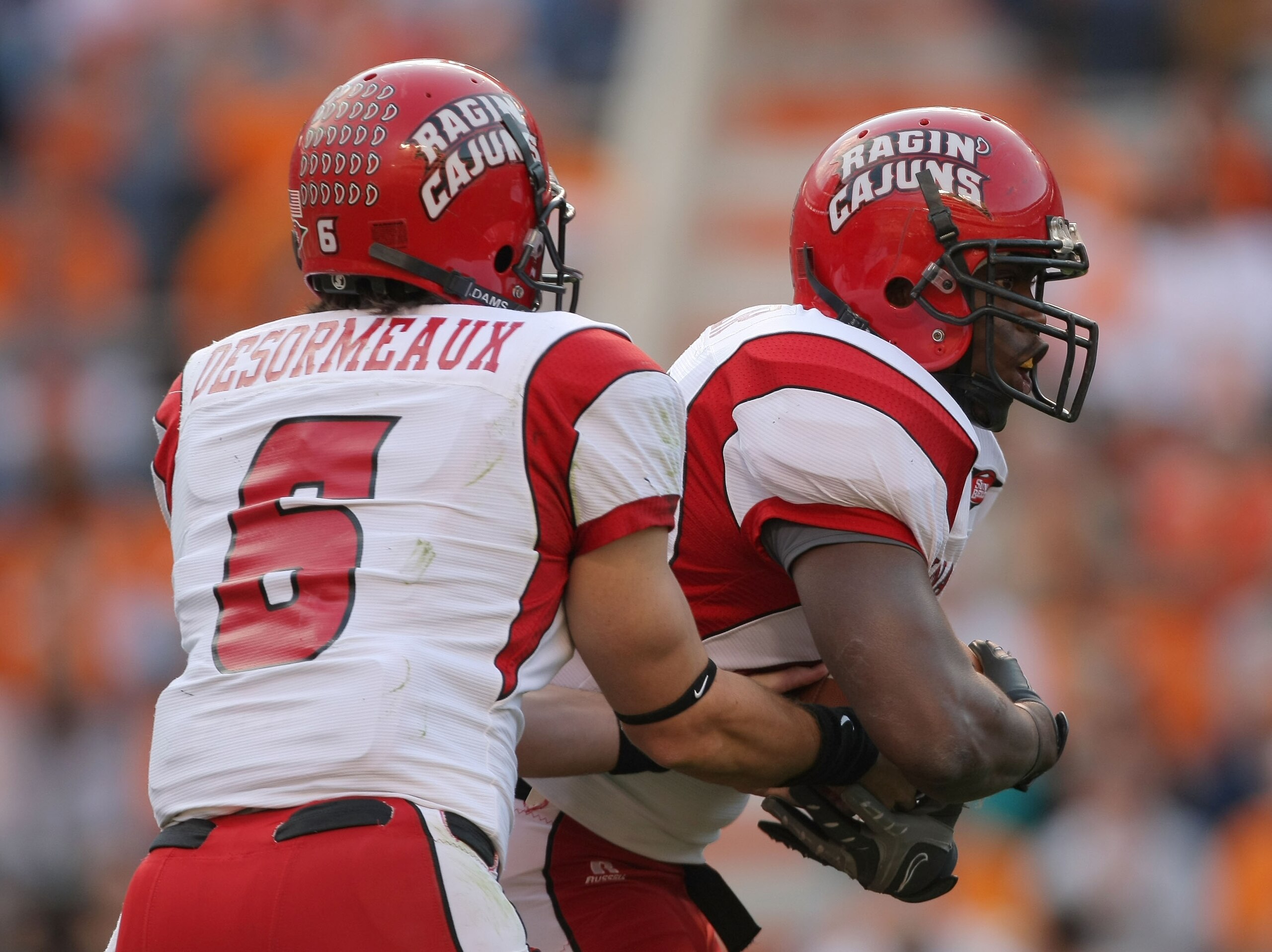 KNOXVILLE, TN - NOVEMBER 03:  Abdule Levier #22 of the Louisiana Lafayette Cajuns takes a handoff from Michael Desormeaux #6 against the Tennessee Volunteers during the second quarter at Neyland Stadium on November 3, 2007 in Knoxville, Tennessee.  (Photo
