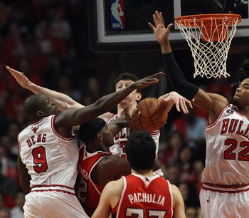 CHICAGO, IL - MAY 10: Joe Johnson #2 of the Atlanta Hawks is surrounded by (L-R) Loul Deng #9, Omer Asik #3 and Taj Gibson #22 of the Chicago Bulls in Game Five of the Eastern Conference Semifinals in the 2011 NBA Playoffs at the United Center on May 10,
