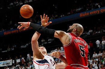 ATLANTA, GA - MAY 12:  Carlos Boozer #5 of the Chicago Bulls battles for a rebound against Zaza Pachulia #27 of the Atlanta Hawks in Game Six of the Eastern Conference Semifinals in the 2011 NBA Playoffs at Phillips Arena on May 12, 2011 in Atlanta, Georg