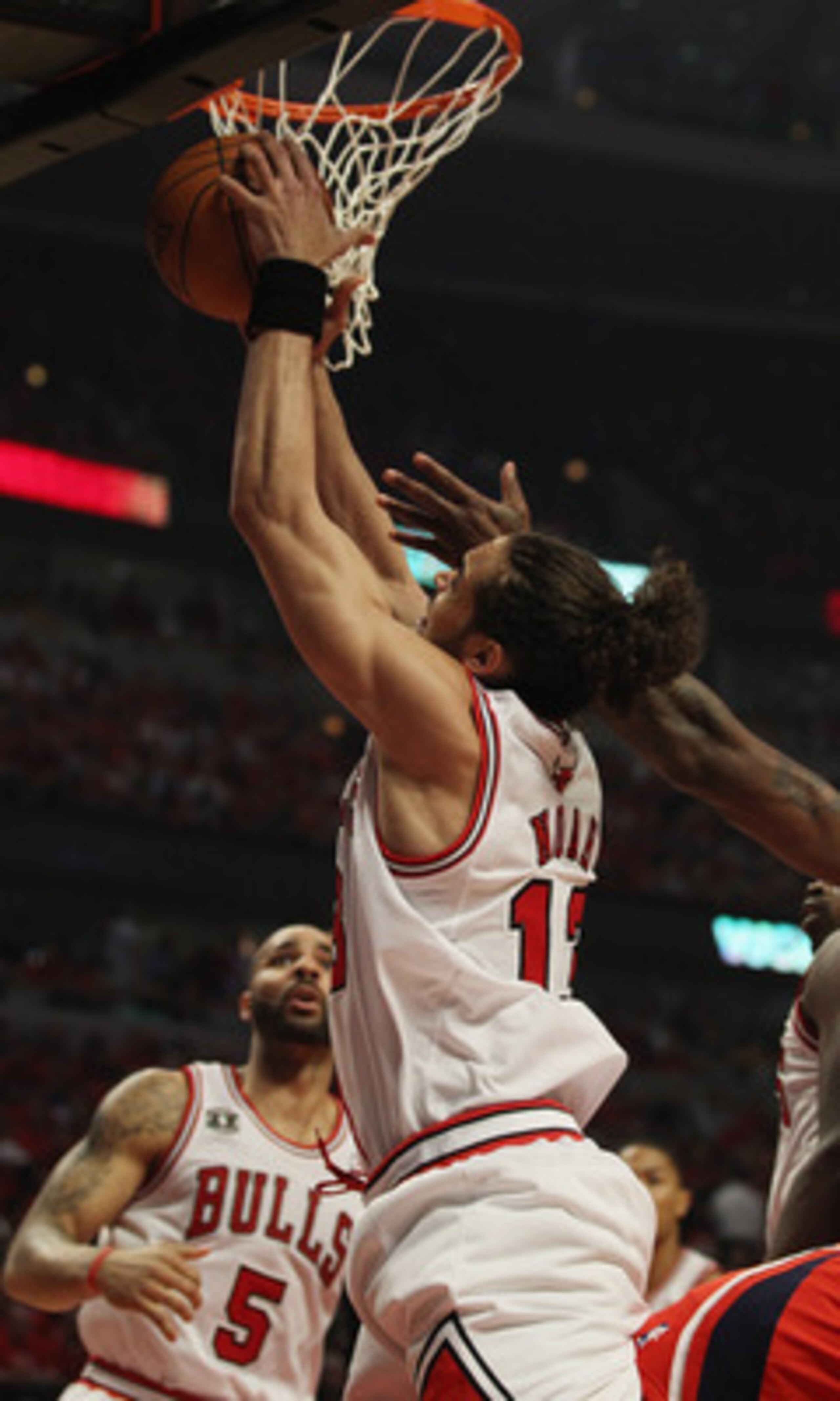 CHICAGO, IL - MAY 10: Joakim Noah #13 of the Chicago Bulls grabs a rebound against the Atlanta Hawks in Game Five of the Eastern Conference Semifinals in the 2011 NBA Playoffs at the United Center on May 10, 2011 in Chicago, Illinois. The Bulls defeated t