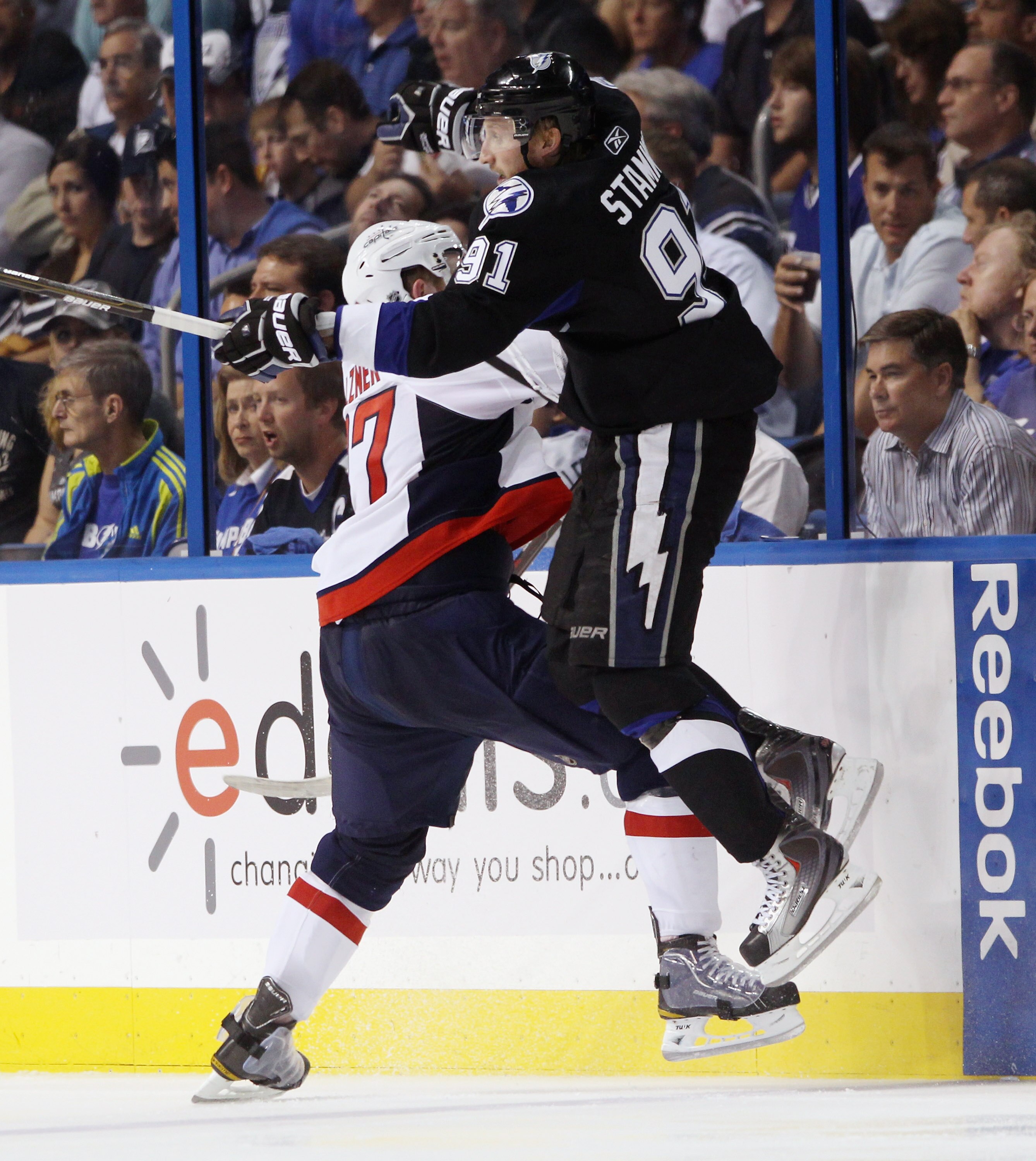 TAMPA, FL - MAY 04: Steven Stamkos #91 of the Tampa Bay Lightning is hit by Karl Alzner #27 of the Washington Capitals in Game Four of the Eastern Conference Semifinals during the 2011 NHL Stanley Cup Playoffs at the St Pete Times Forum on May 4, 2011 in