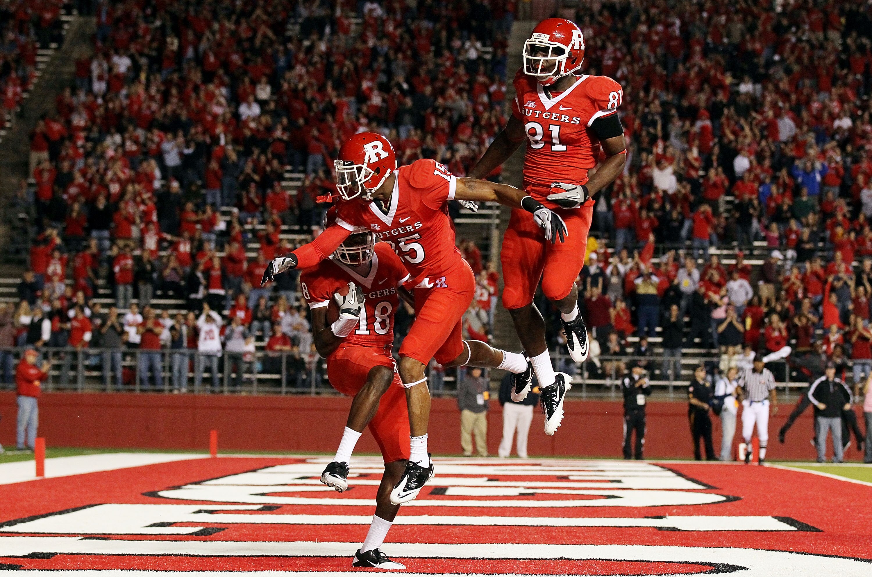 PISCATAWAY, NJ - OCTOBER 08:  Jeremy Deering #18 of the Rutgers Scarlet Knights celebrates his first-quarter touchdown against the Connecticut Huskies with teammates Keith Stroud #15 and Mark Harrison #81 at Rutgers Stadium on October 8, 2010 in Piscatawa