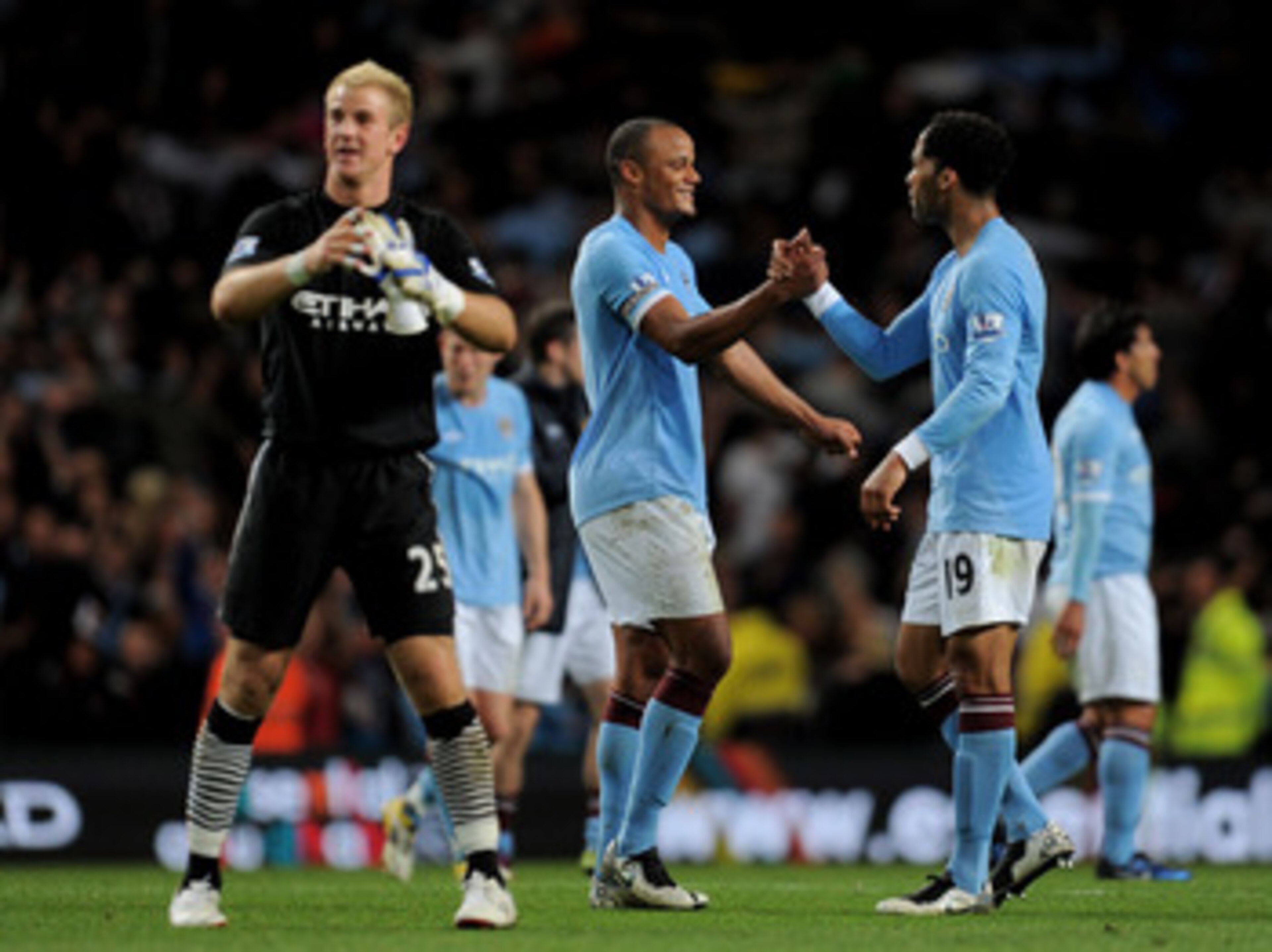 MANCHESTER, ENGLAND - MAY 10: Joe Hart (L), Vincent Kompany and Joleon Lescott (R) of Manchester City celebrate at the end of the Barclays Premier League match between Manchester City and Tottenham Hotspur at the City of Manchester Stadium on May 10, 201 MANCHESTER, ENGLAND - MAY 10: Joe Hart (L), Vincent Kompany and Joleon Lescott (R) of Manchester City celebrate at the end of the Barclays Premier League match between Manchester City and Tottenham Hotspur at the City of Manchester Stadium on May 10, 201