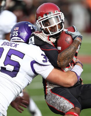 SALT LAKE CITY, UT - NOVEMBER 6: Jereme Brooks #85 of the Utah Utes is hit by Tanner Brock #35 of the TCU Horned Frogs during the first half of an NCAA football game November 6, 2010 at Rice-Eccles Stadium in Salt Lake City, Utah. (Photo by George Frey/Ge SALT LAKE CITY, UT - NOVEMBER 6: Jereme Brooks #85 of the Utah Utes is hit by Tanner Brock #35 of the TCU Horned Frogs during the first half of an NCAA football game November 6, 2010 at Rice-Eccles Stadium in Salt Lake City, Utah. (Photo by George Frey/Ge