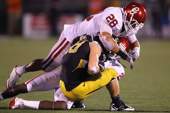 COLUMBIA, MISSOURI - OCTOBER 23: T.J. Moe #28 of the Missouri Tigers is tackled by Travis Lewis #28 of the Oklahoma Sooners at Faurot Field/Memorial Stadium on October 23, 2010 in Columbia, Missouri. The Tigers beat the Sooners 36-27. (Photo by Dilip Vi COLUMBIA, MISSOURI - OCTOBER 23: T.J. Moe #28 of the Missouri Tigers is tackled by Travis Lewis #28 of the Oklahoma Sooners at Faurot Field/Memorial Stadium on October 23, 2010 in Columbia, Missouri. The Tigers beat the Sooners 36-27. (Photo by Dilip Vi