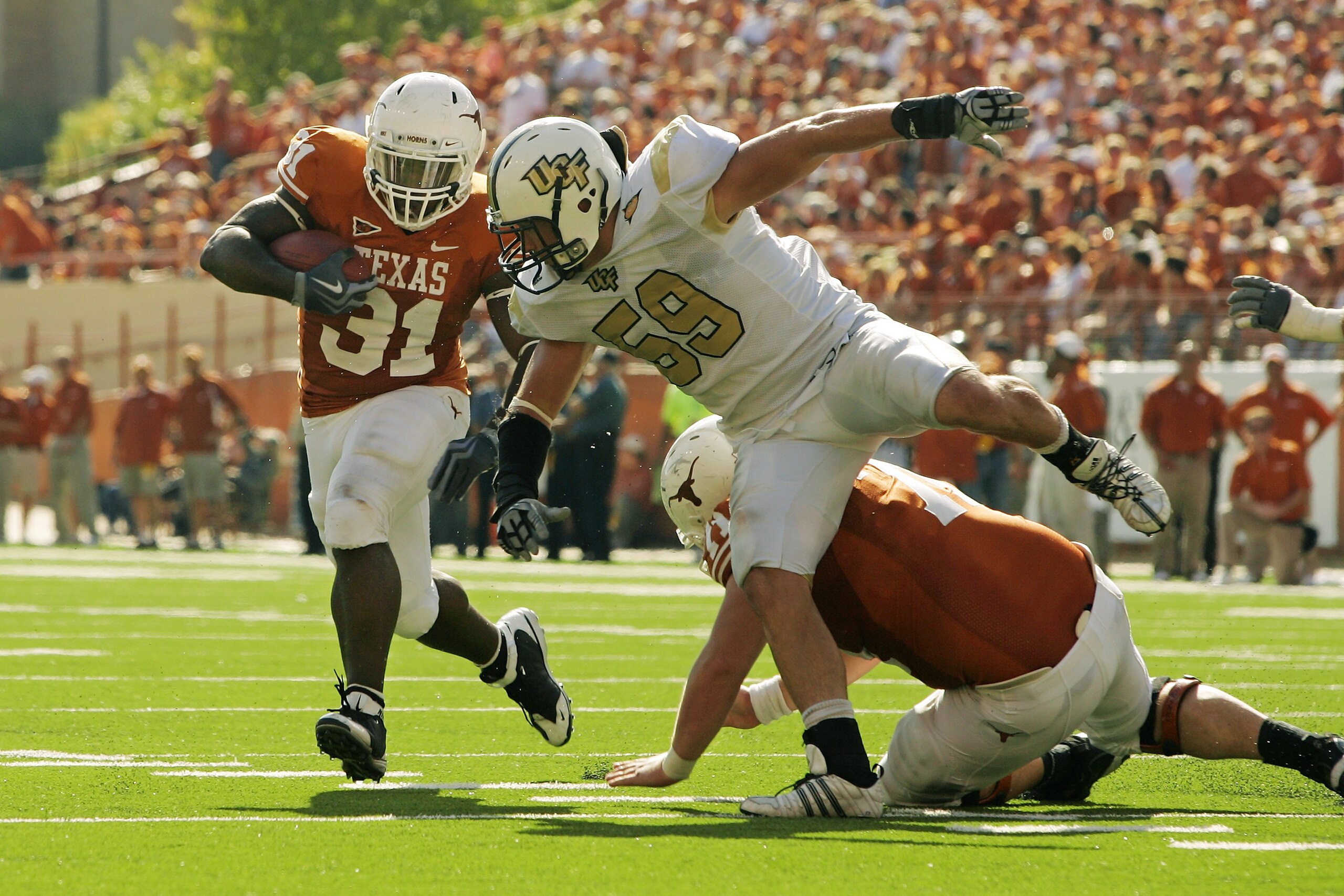 AUSTIN, TX - NOVEMBER 07:  Running back Cody Johnson #31 of the Texas Longhorns runs with the ball against linebacker Cory Hogue #59 of the UCF Knights on November 7, 2009 at Darrell K Royal - Texas Memorial Stadium in Austin, Texas.  Texas won 35-3.  (Ph