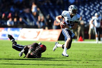 SAN DIEGO - OCTOBER 17: Max Hall #15 of BYU Cougars runs the ball and avoids getting tackeled by Miles Burris #9 of San Diego State Aztecs at Qualcomm Stadium on October 17, 2009 in San Diego, California. BYU Cougars defeated the Aztecs 38-28 (Photo by SAN DIEGO - OCTOBER 17: Max Hall #15 of BYU Cougars runs the ball and avoids getting tackeled by Miles Burris #9 of San Diego State Aztecs at Qualcomm Stadium on October 17, 2009 in San Diego, California. BYU Cougars defeated the Aztecs 38-28 (Photo by
