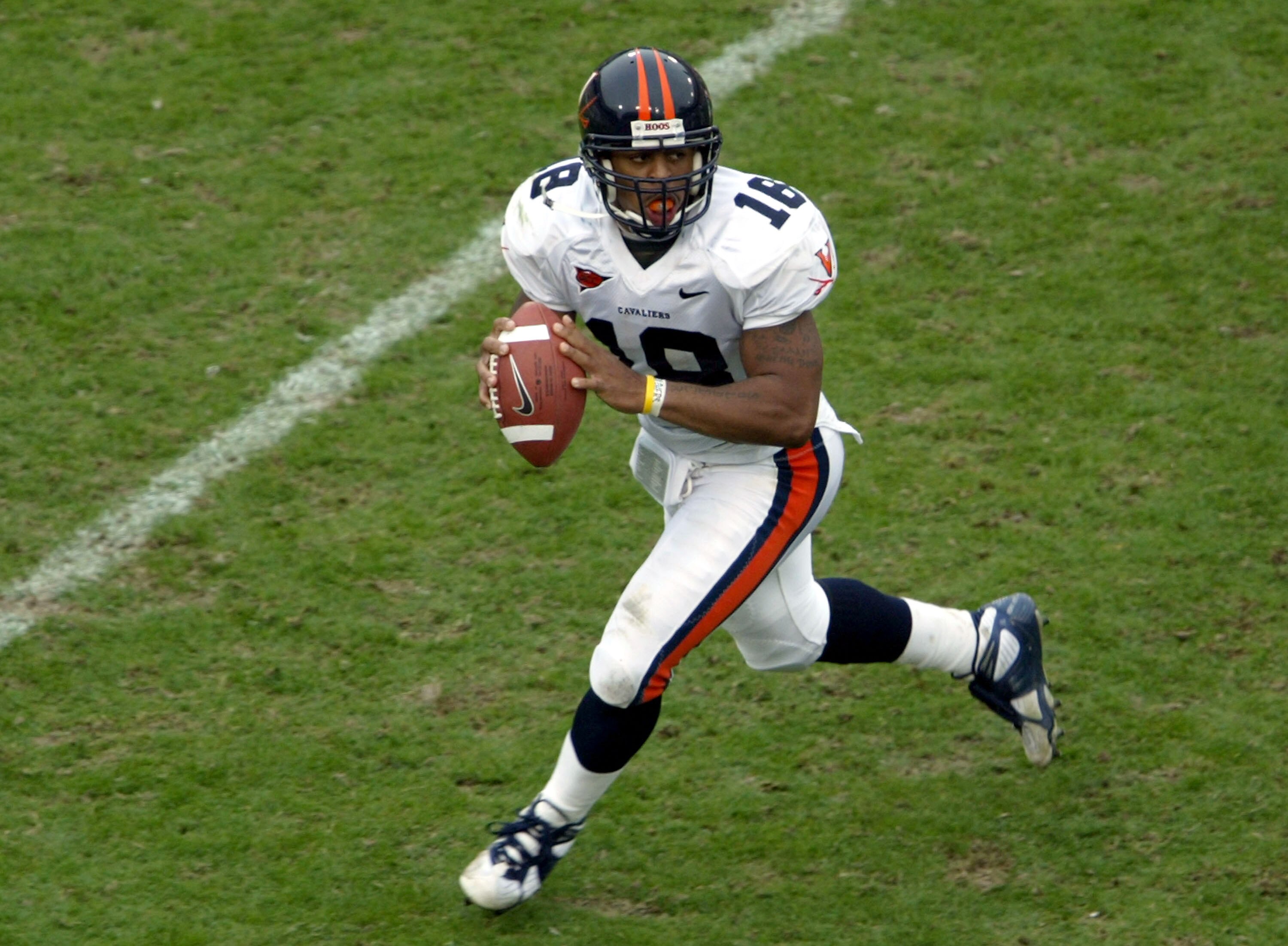 ATLANTA - NOVEMBER 20:  Quarterback Marques Hagans #18 of the Virginia Cavaliers rolls out looking for a reciever as the Cavs defeated the Yellow Jackets 30-10 during NCAA football action at Bobby Dodd Stadium on November 20, 2004 in Atlanta, Georgia. (Ph