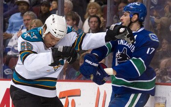 VANCOUVER, CANADA - JANUARY 20: Ryan Kesler #17 of the Vancouver Canucks and Derek Joslin #65 of the San Jose Sharks push and shove behind the play during the second period in NHL action on January 20, 2011 at Rogers Arena in Vancouver, BC, Canada.  (Phot