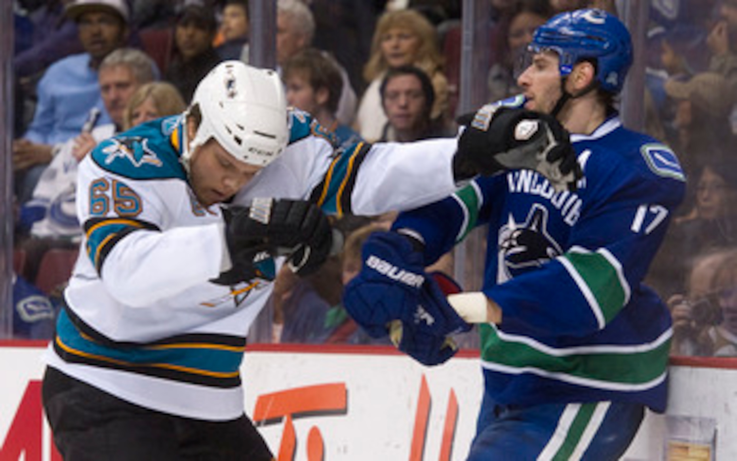 VANCOUVER, CANADA - JANUARY 20: Ryan Kesler #17 of the Vancouver Canucks and Derek Joslin #65 of the San Jose Sharks push and shove behind the play during the second period in NHL action on January 20, 2011 at Rogers Arena in Vancouver, BC, Canada.  (Phot