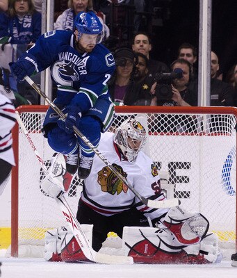 VANCOUVER, CANADA - APRIL 26: Daniel Sedin #22 of the Vancouver Canucks jumps out of the way as goalie Corey Crawford #50 of the Chicago Blackhawks makes a pad save during the second period in Game Seven of the Western Conference Quarterfinals during the