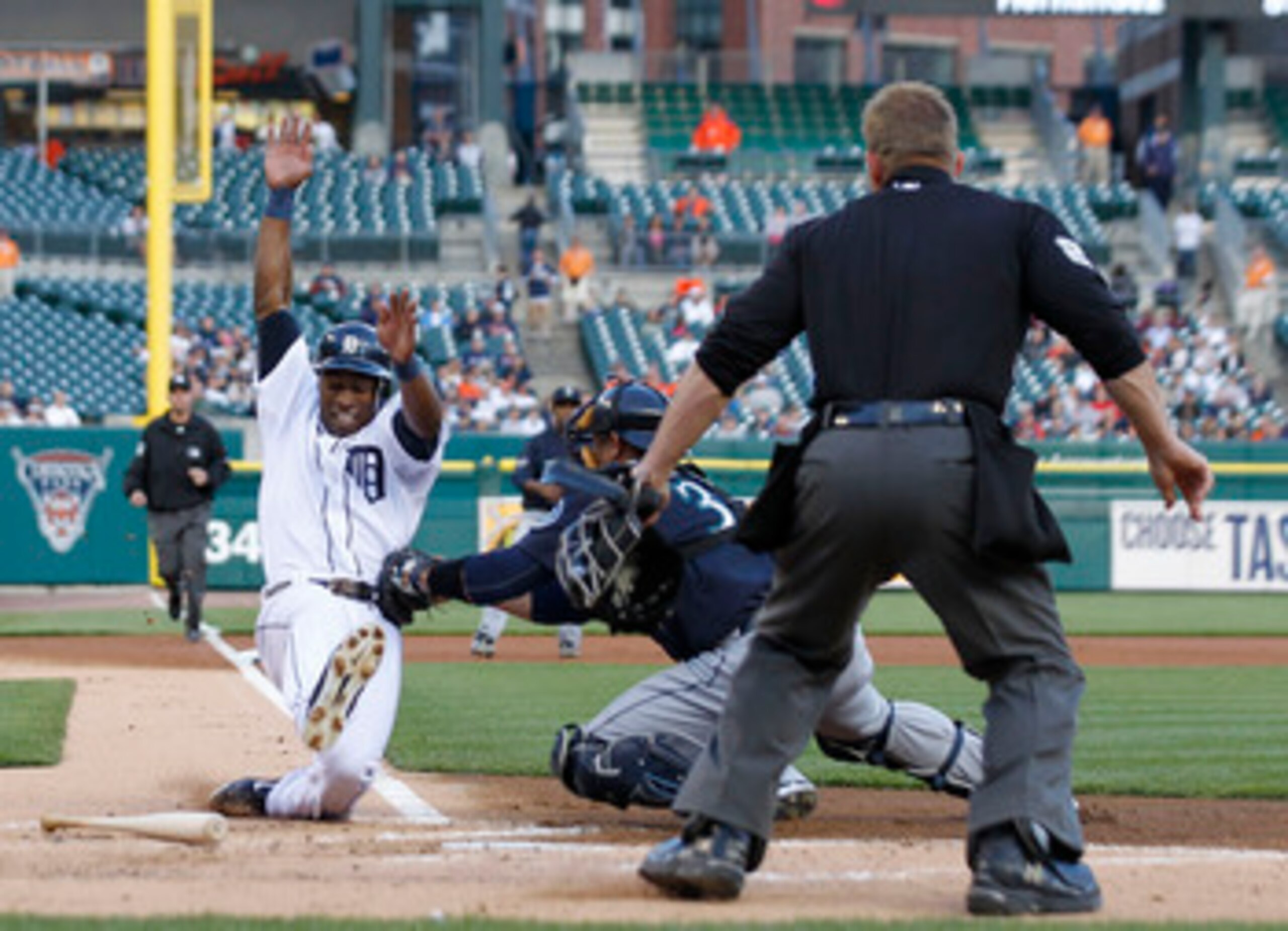 DETROIT - APRIL 26: Austin Jackson #14 of the Detroit Tigers is tagged out at home by Miguel Olivo #30 of the Seattle Mariners in the first inning at Comerica Park on April 26, 2011 in Detroit, Michigan.  (Photo by Leon Halip/Getty Images)