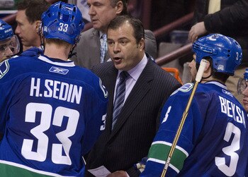 VANCOUVER, CANADA - APRIL 28: Head Coach Alain Vigneault (middle) speaks with Henrik Sedin #33 and Kevin Bieksa #3 of the Vancouver Canucks during a timeout in the third period in Game One of the Western Conference Semifinals against the Nashville Predato