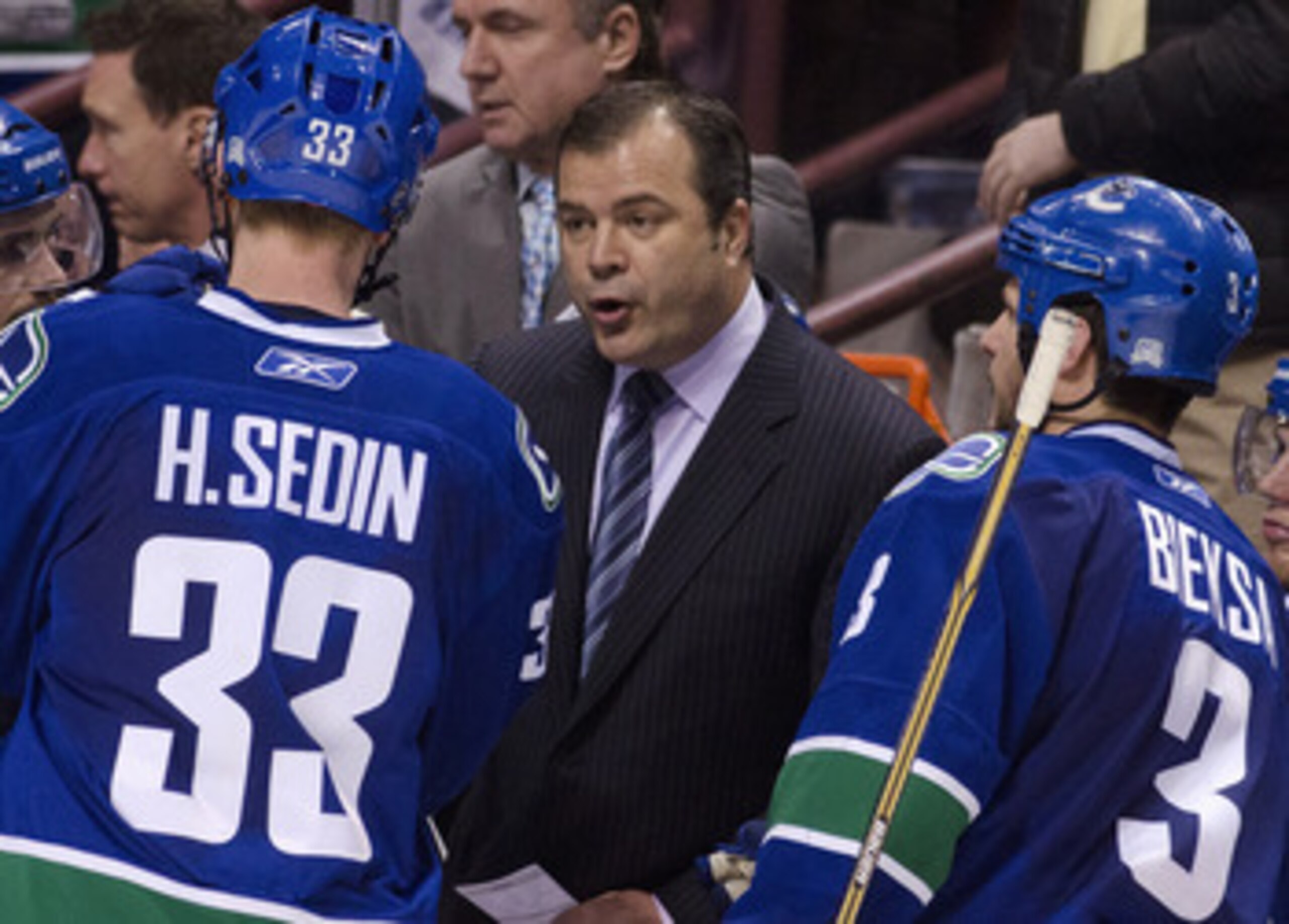 VANCOUVER, CANADA - APRIL 28: Head Coach Alain Vigneault (middle) speaks with Henrik Sedin #33 and Kevin Bieksa #3 of the Vancouver Canucks during a timeout in the third period in Game One of the Western Conference Semifinals against the Nashville Predato
