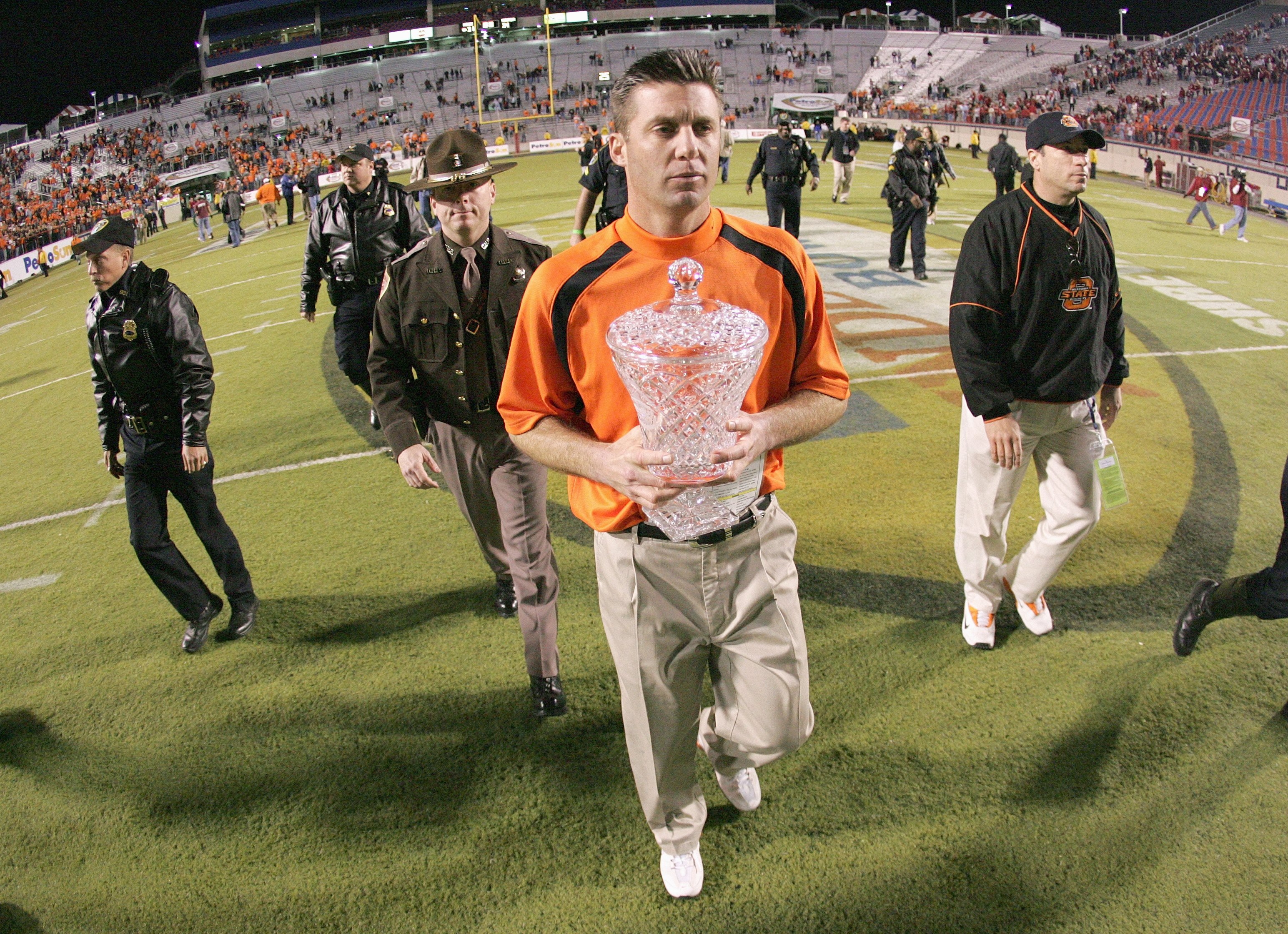 SHREVEPORT, LA - DECEMBER 28: Head coach Mike Gundy of Oklahoma State carries the PetroSun Independence Bow trophy after the win against Alabama on December 28, 2006 at Independence Stadium in Shreveport, Louisiana. (Photo by Chris Graythen/Getty Images)