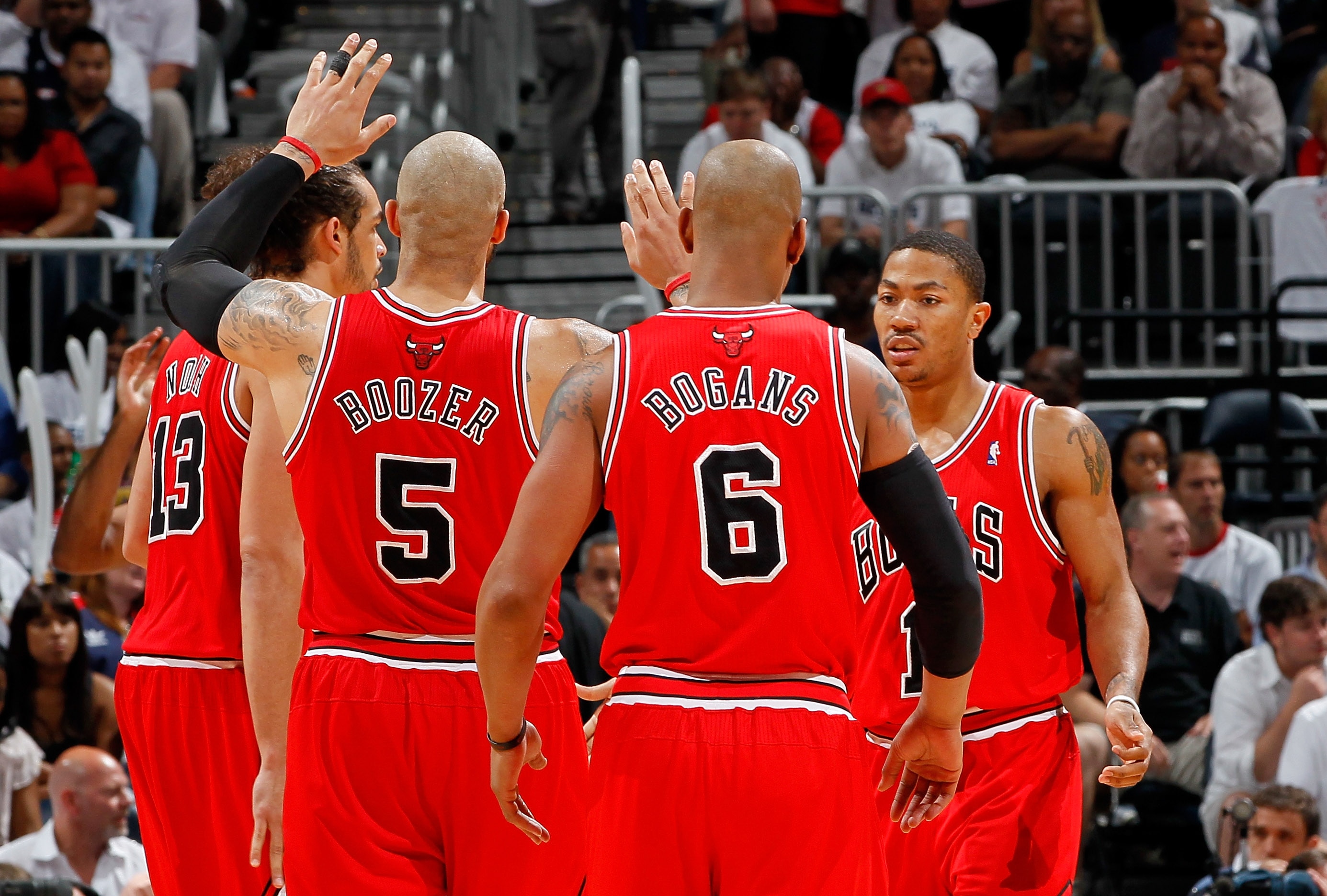 ATLANTA, GA - MAY 12:  Derrick Rose #1 of the Chicago Bulls reacts after drawing a foul from the Atlanta Hawks with Joakim Noah #13, Carlos Boozer #5 and Keith Bogans #6 in Game Six of the Eastern Conference Semifinals in the 2011 NBA Playoffs at Phillips