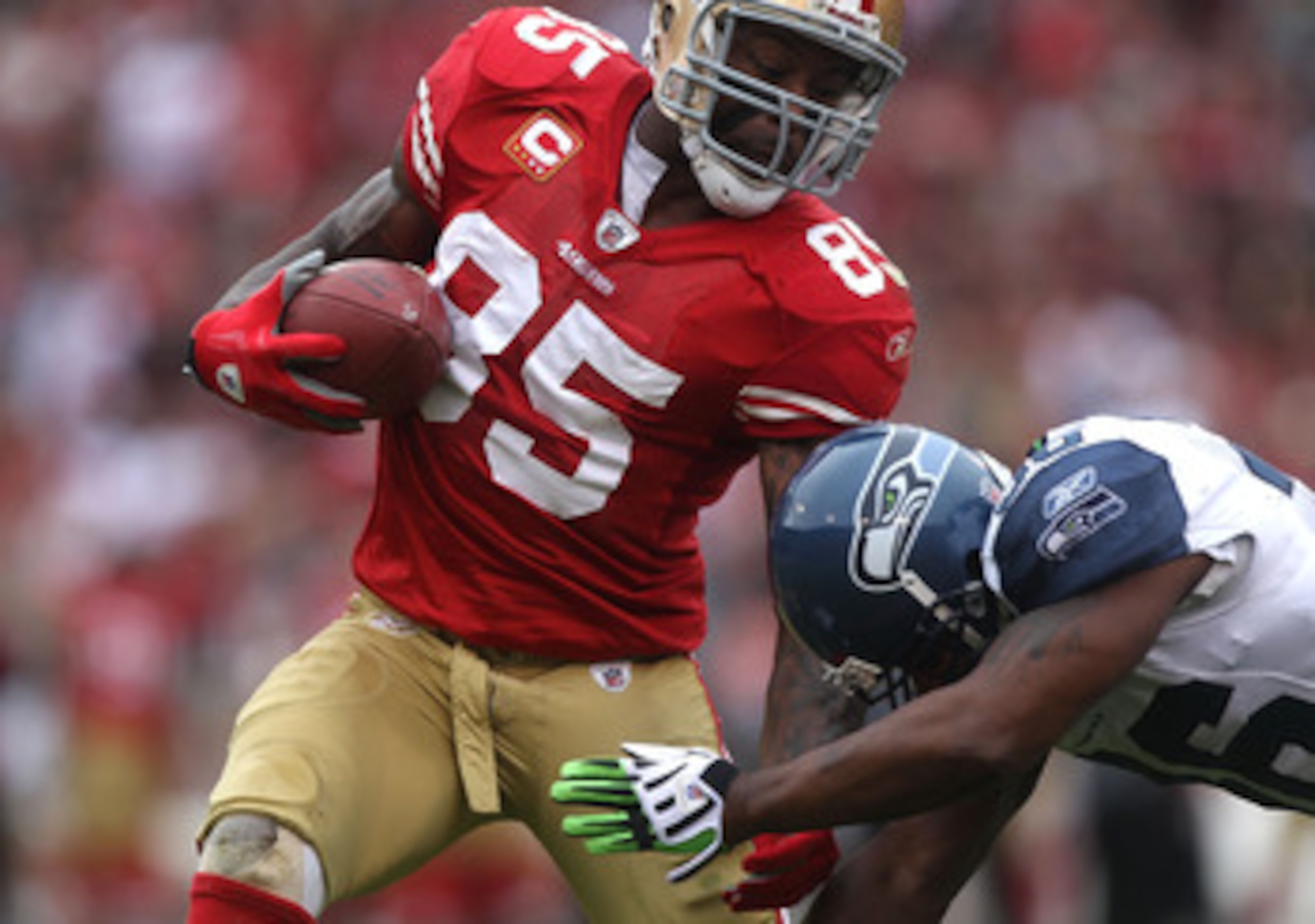 SAN FRANCISCO - DECEMBER 12:  Vernon Davis #85 of the San Francisco 49ers runs after a catch as Lawyer Milloy #36 of the Seattle Seahawks defends during an NFL game at Candlestick Park on December 12, 2010 in San Francisco, California.  (Photo by Jed Jaco