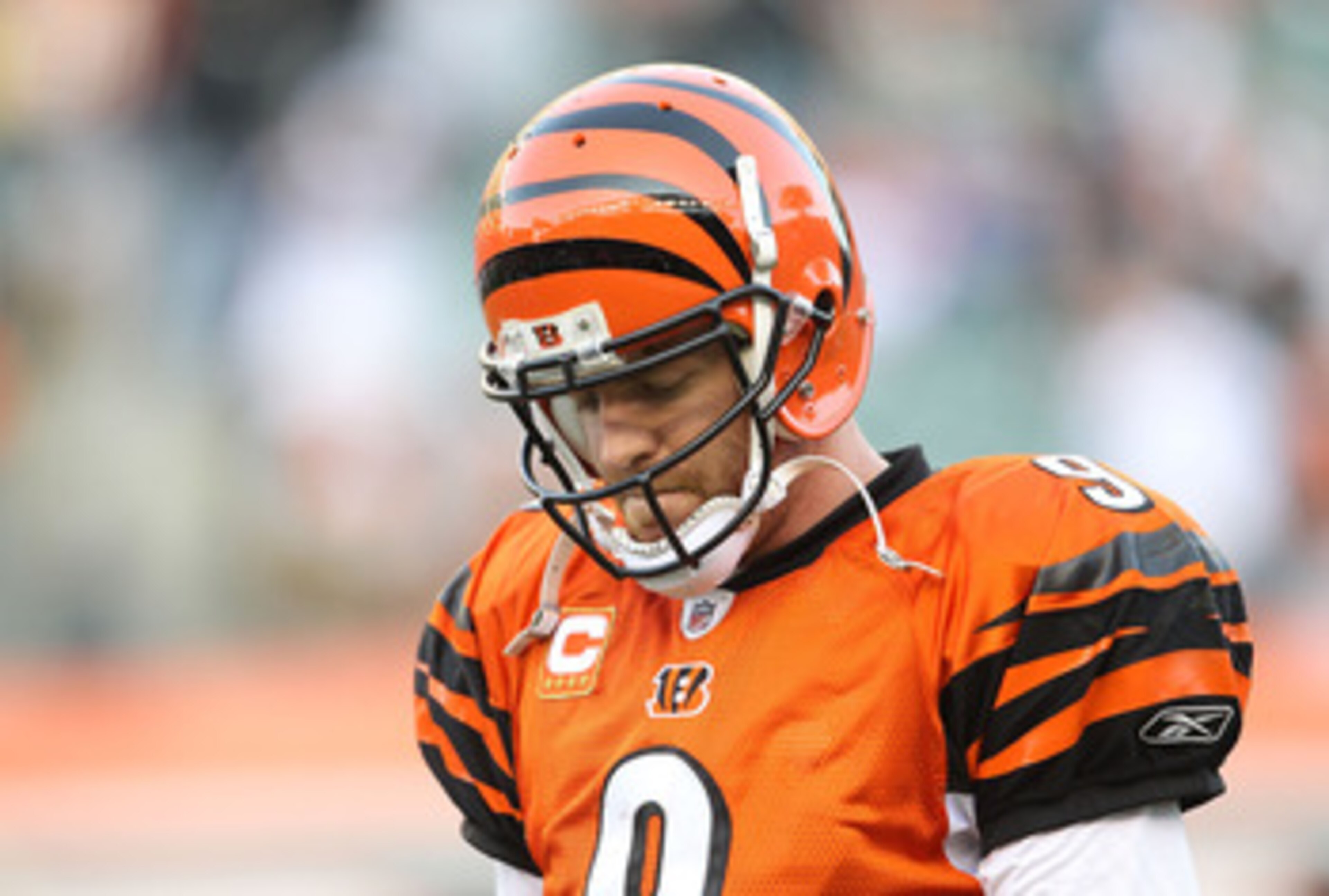 CINCINNATI - NOVEMBER 21:  Carson Palmer #9 of the Cincinnati Bengals walks off of the field after throwing an interception late in the fourth quarter of the Bengals 49-31 loss to the Buffalo Bills at Paul Brown Stadium on November 21, 2010 in Cincinnati,