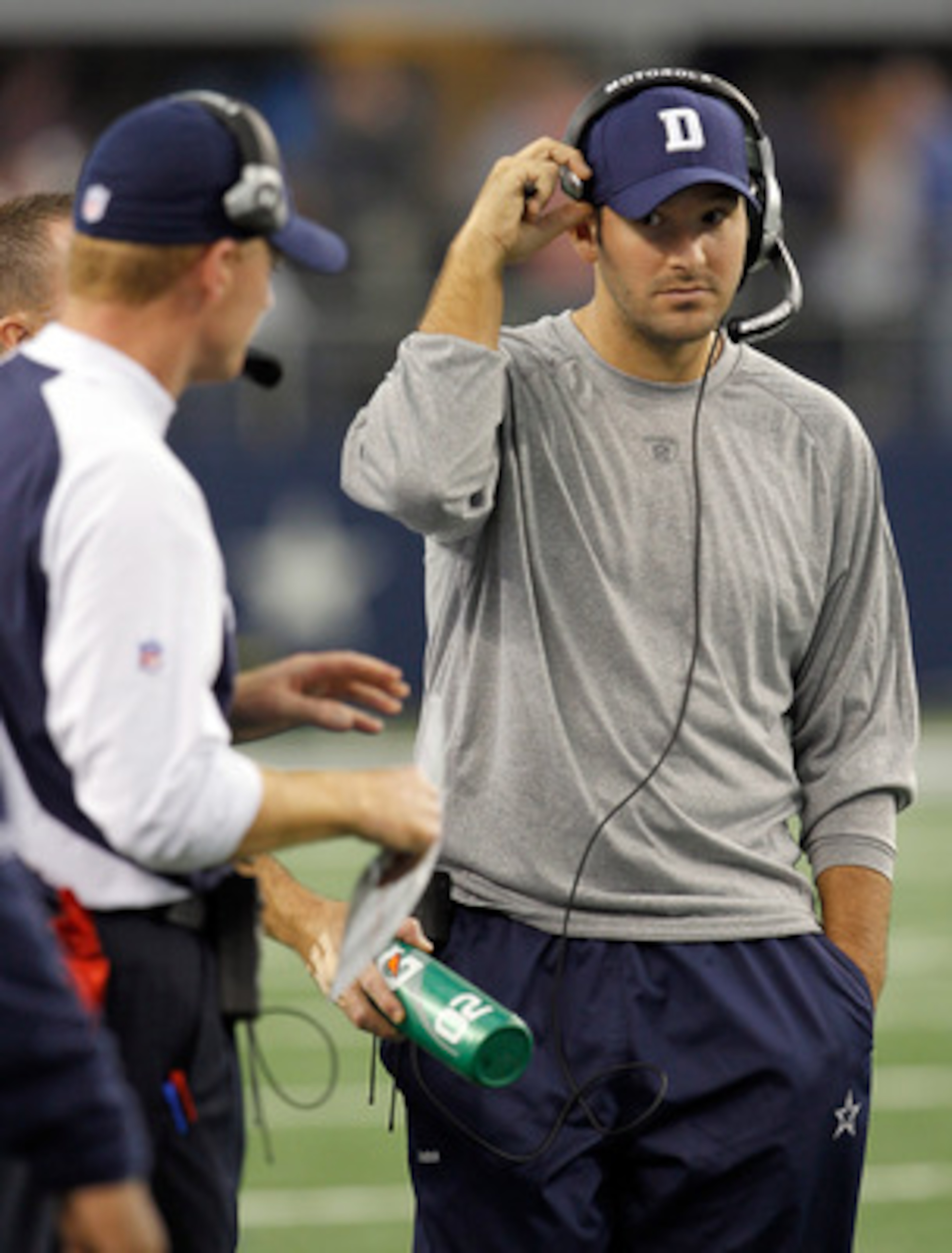 ARLINGTON, TX - NOVEMBER 21:  Injured quarterback Tony Romo #9 of the Dallas Cowboys stands on the sidelines with head coach Jason Garrett at Cowboys Stadium on November 21, 2010 in Arlington, Texas.  The Cowboys beat the Detroit Lions 35-19 with backup q