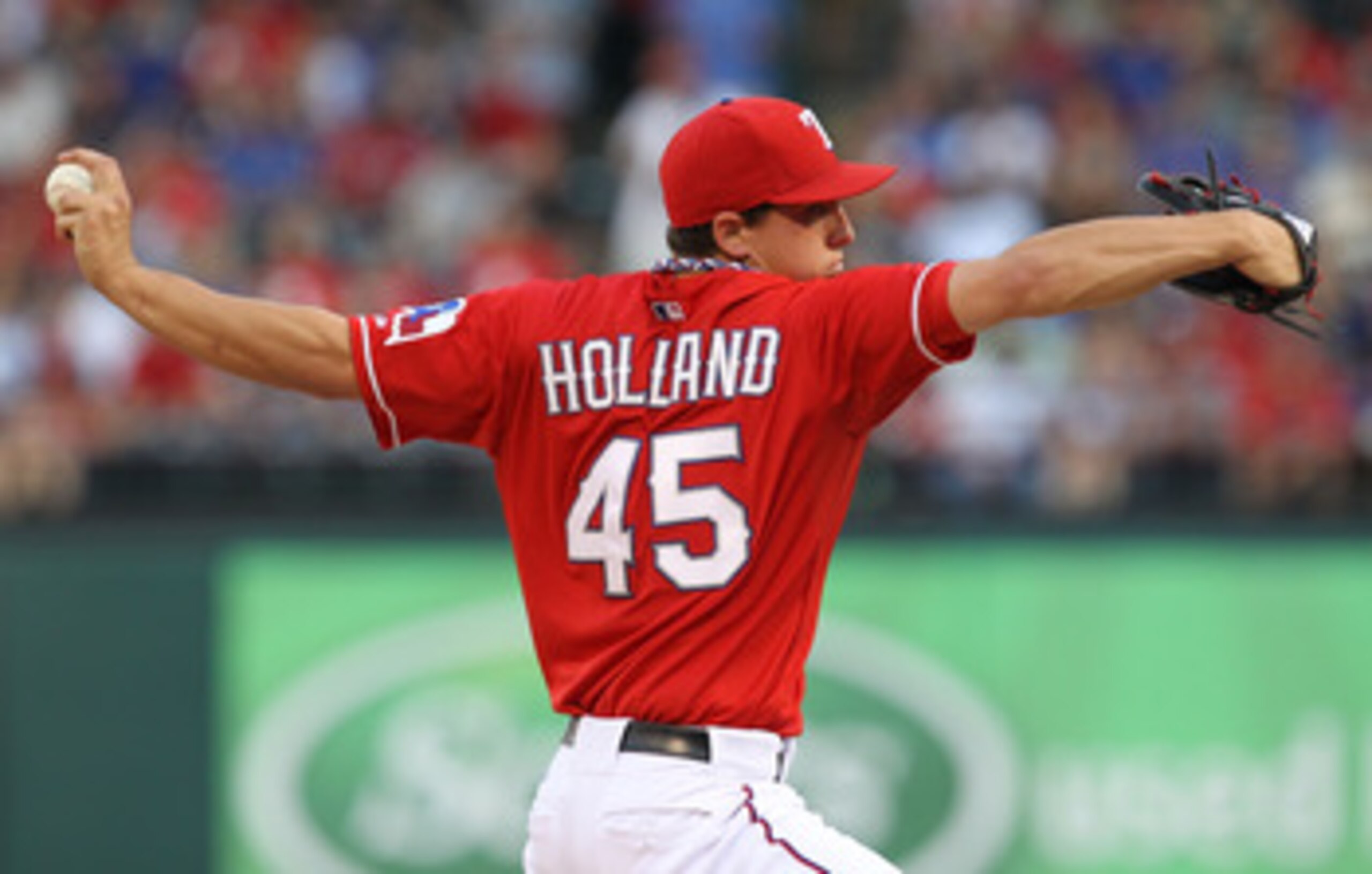 ARLINGTON, TX - MAY 07:  Pitcher Derek Holland #45 of the Texas Rangers throws against the New York Yankees in the first inning at Rangers Ballpark in Arlington on May 7, 2011 in Arlington, Texas.  (Photo by Ronald Martinez/Getty Images)
