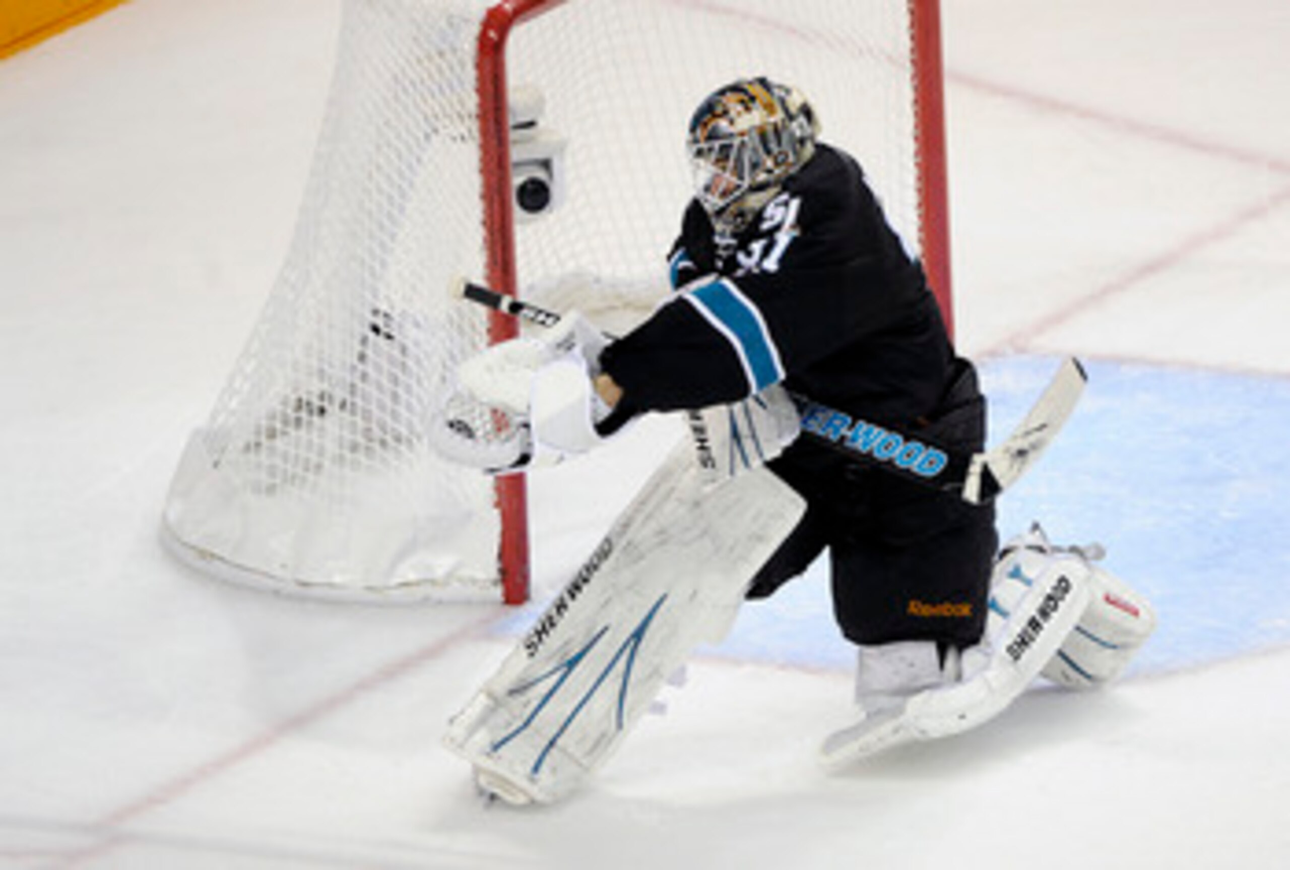 SAN JOSE, CA - MAY 12: Goalie Antti Niemi #31 of the San Jose Sharks makes a glove-hand save late in the third period against the Detroit Red Wings in Game Seven of the Western Conference Semifinals  during the 2011 NHL Stanley Cup Playoffs at the HP Pavi