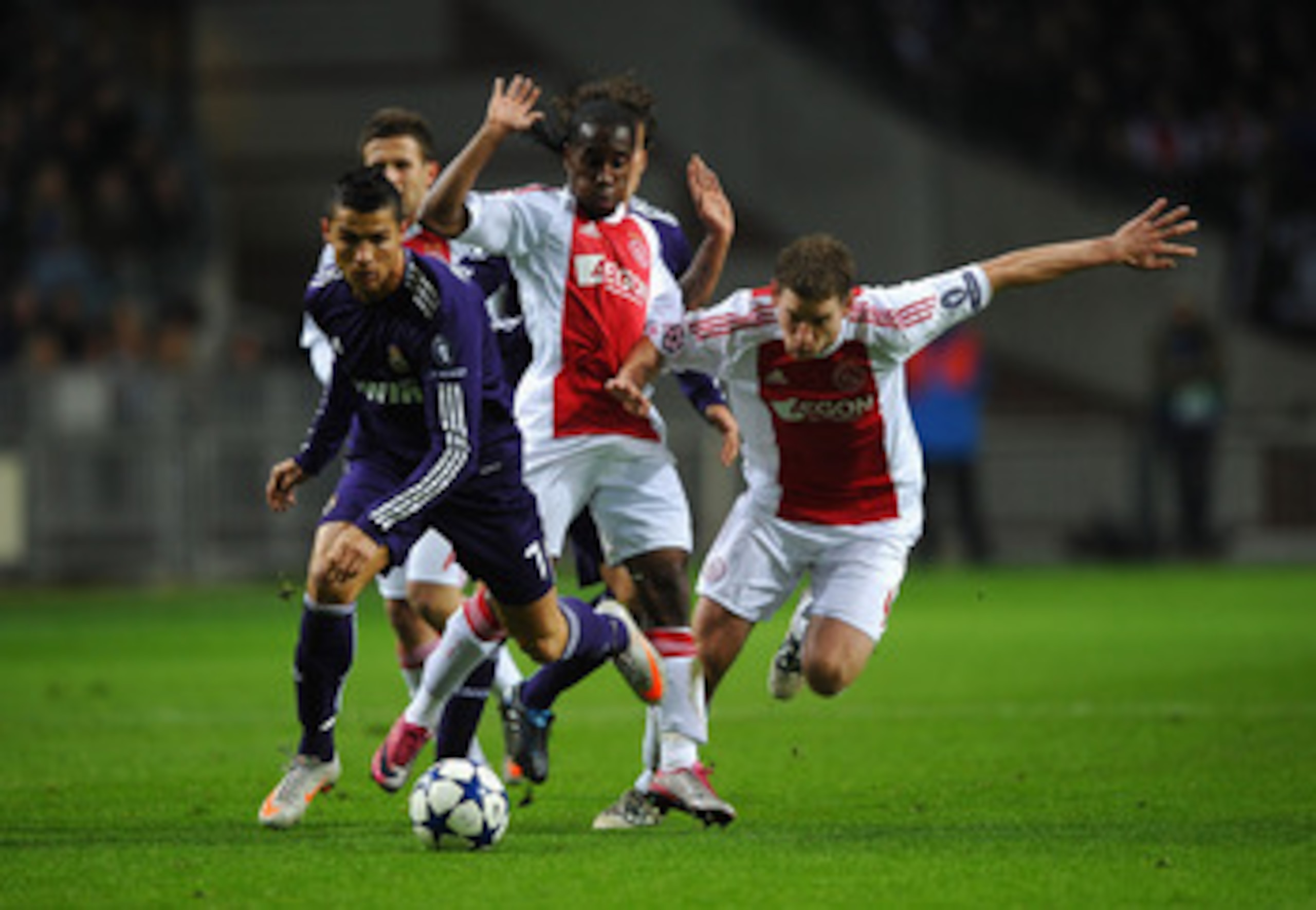 AMSTERDAM, NETHERLANDS - NOVEMBER 23: Cristiano Ronaldo of Real Madrid battles for the ball with Jan Vertonghen of Ajax during the UEFA Champions League Group G match between AFC Ajax and Real Madrid at the Ajax Arena on November 23, 2010 in Amsterdam, Ne