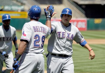 OAKLAND, CA - MAY 02:  Mitch Moreland #18 is congratulated by Adrian Beltre #29 of the Texas Rangers after he scored on a double by Michael Young #10 in the third inning against the Oakland Athletics at Oakland-Alameda County Coliseum on May 2, 2011 in Oa