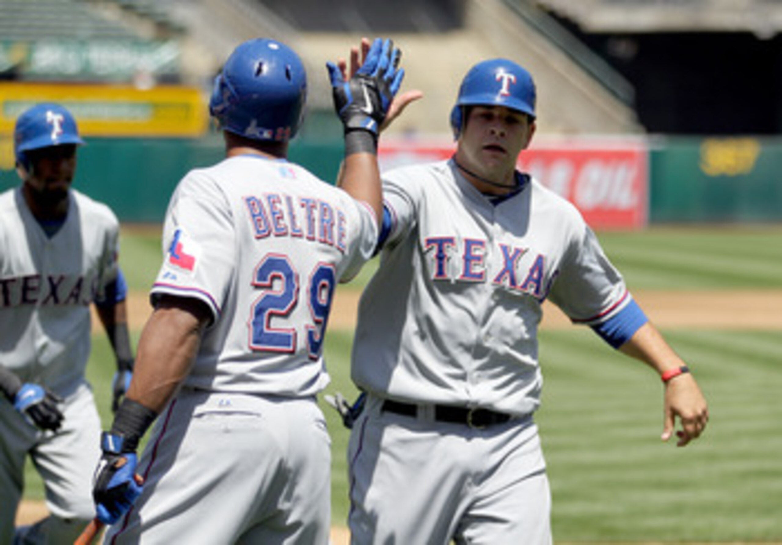 OAKLAND, CA - MAY 02:  Mitch Moreland #18 is congratulated by Adrian Beltre #29 of the Texas Rangers after he scored on a double by Michael Young #10 in the third inning against the Oakland Athletics at Oakland-Alameda County Coliseum on May 2, 2011 in Oa