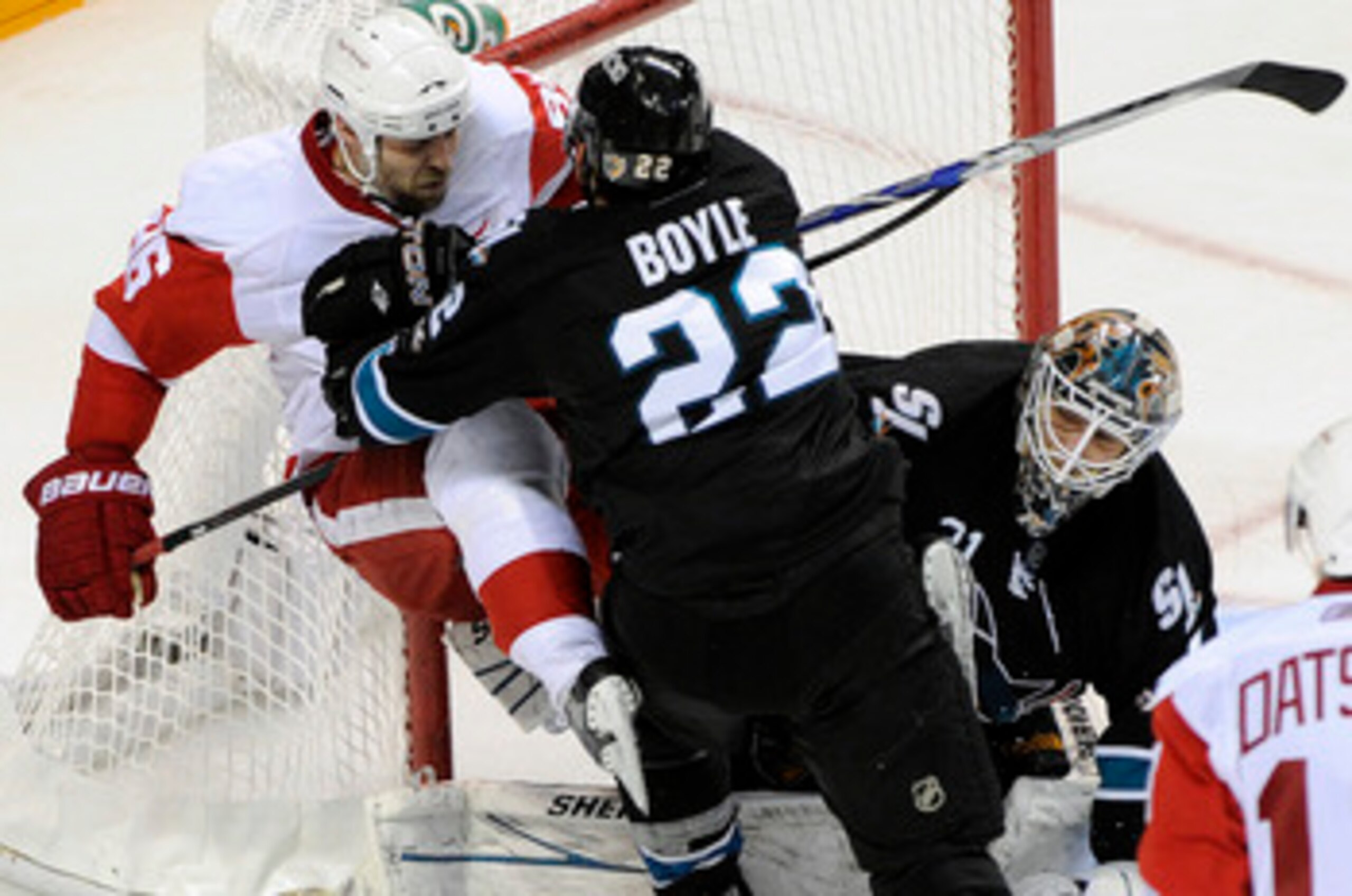 SAN JOSE, CA - MAY 12: Dan Boyle #22 of the San Jose Sharks check into the pole of the goal Tomas Holmstrom #96 of the Detroit Red Wings in Game Seven of the Western Conference Semifinals  during the 2011 NHL Stanley Cup Playoffs at the HP Pavilion on May