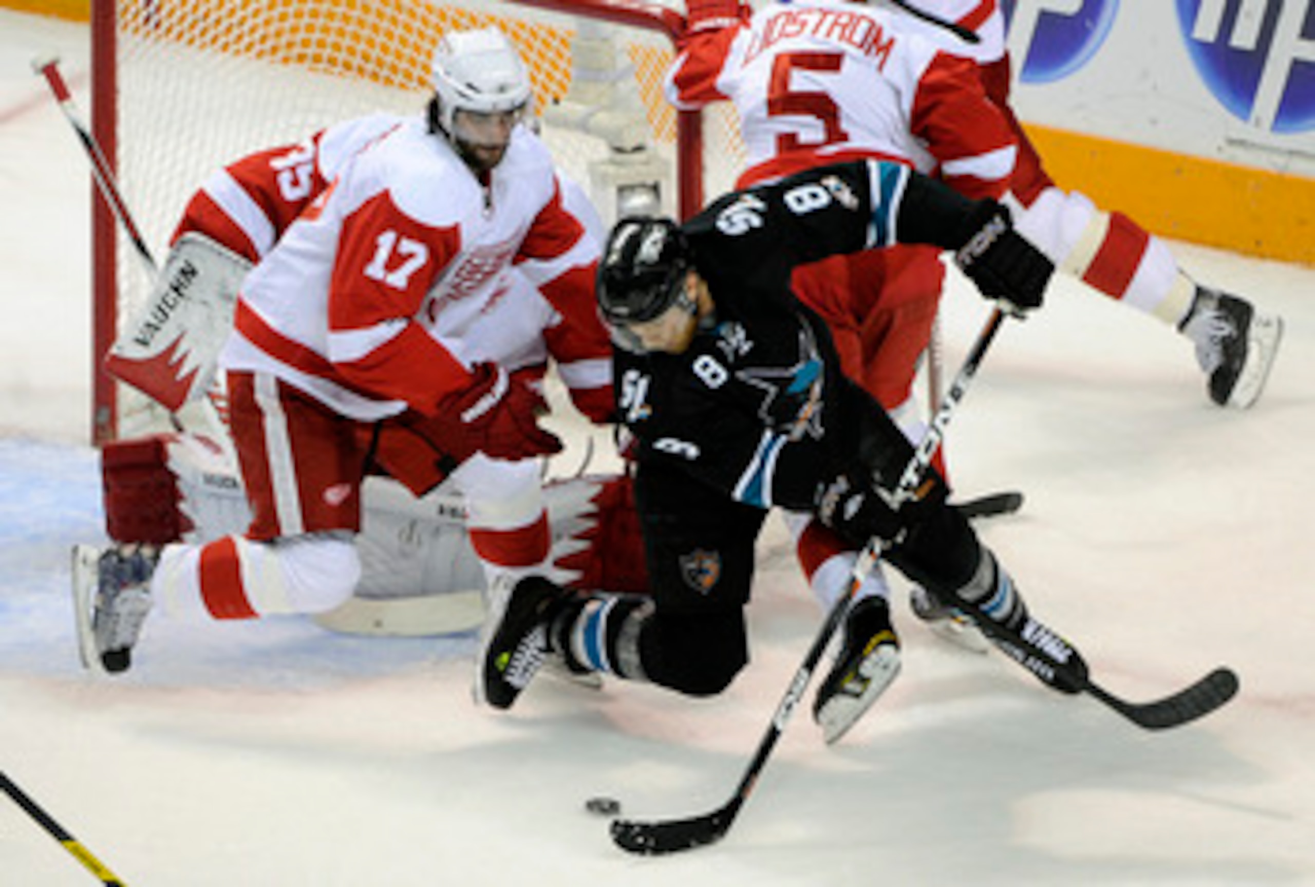 SAN JOSE, CA - MAY 12: Joe Pavelski #8 of the San Jose Sharks tries to get a backhand shot past Patrick Eaves #17 and Jimmy Howard #35 the Detroit Red Wings in Game Seven of the Western Conference Semifinals  during the 2011 NHL Stanley Cup Playoffs at th