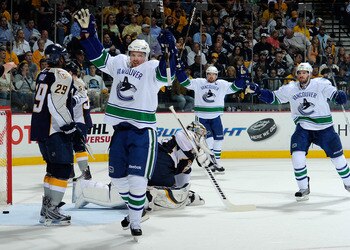 NASHVILLE, TN - MAY 09:  Daniel Sedin #22, Henrik Sedin #33, and Ryan Kesler #17of the Vancouver Canucks celebrate after a goal against Pekka Rinne #35 of the Nashville Predators in Game Six of the Western Conference Semifinals at the Bridgestone Arena on