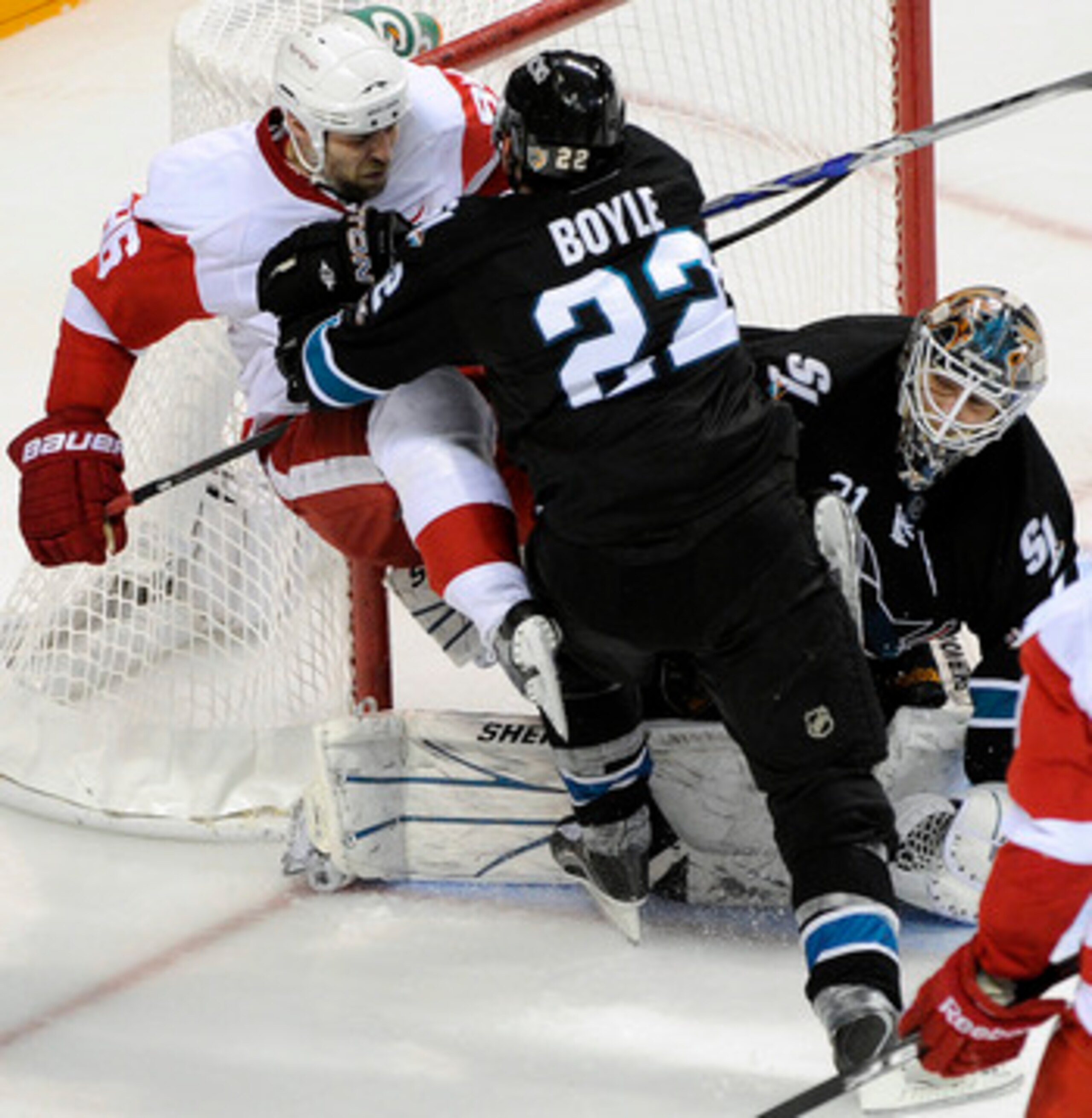 SAN JOSE, CA - MAY 12: Dan Boyle #22 of the San Jose Sharks check into the pole of the goal Tomas Holmstrom #96 of the Detroit Red Wings in Game Seven of the Western Conference Semifinals  during the 2011 NHL Stanley Cup Playoffs at the HP Pavilion on May