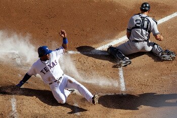 ARLINGTON, TX - OCTOBER 16:  Elvis Andrus #1 of the Texas Rangers slides into home plate to score on a double steal in the bottom of the first inning against Jorge Posada #20 of the New York Yankees in Game Two of the ALCS during the 2010 MLB Playoffs at