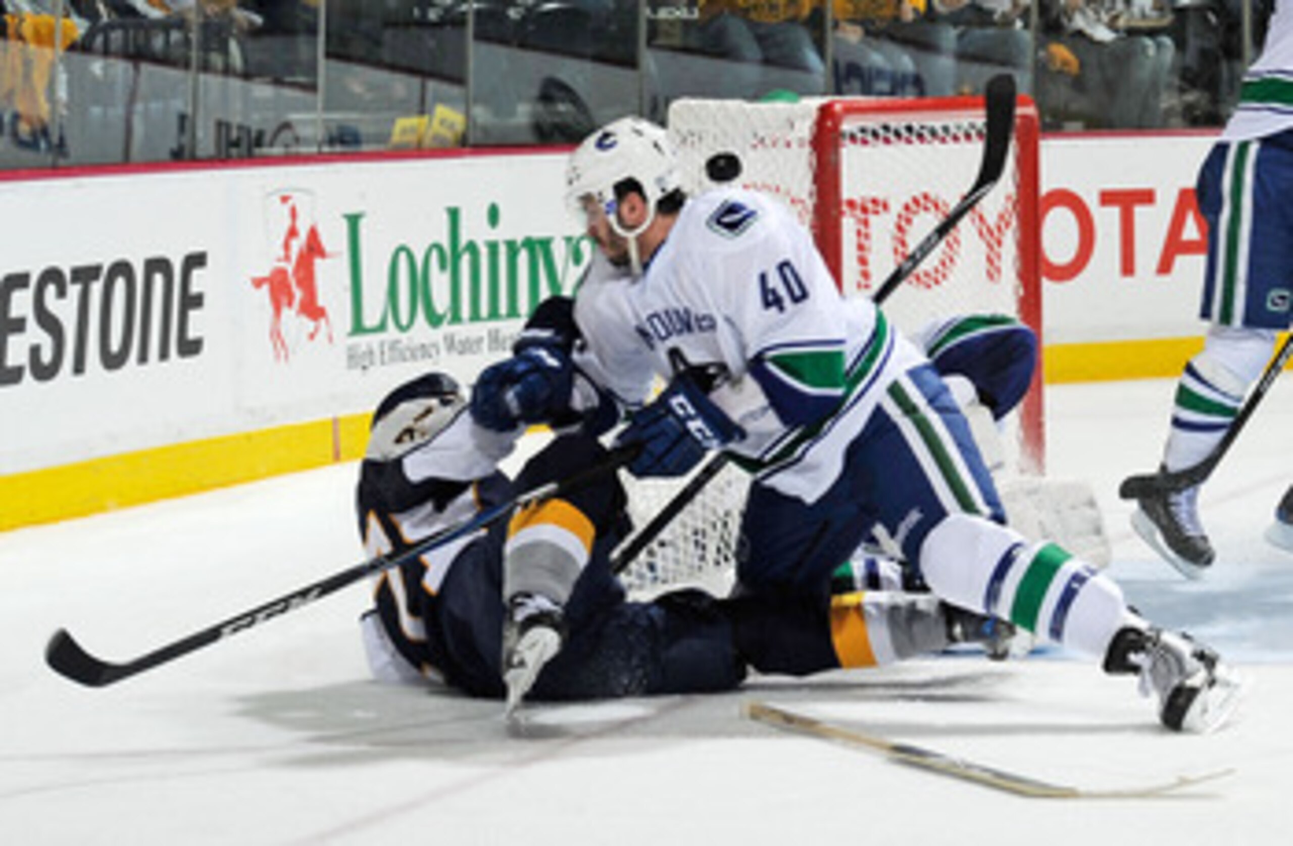 NASHVILLE, TN - MAY 05: Maxim Lapierre #40 of the Vancouver Canucks lays on top of Patric Hornqvist #27 of the Nashville Predators in Game Four of the Western Conference Semifinals at Bridgestone Arena on May 5, 2011 in Nashville, Tennessee. (Photo by F NASHVILLE, TN - MAY 05: Maxim Lapierre #40 of the Vancouver Canucks lays on top of Patric Hornqvist #27 of the Nashville Predators in Game Four of the Western Conference Semifinals at Bridgestone Arena on May 5, 2011 in Nashville, Tennessee. (Photo by F