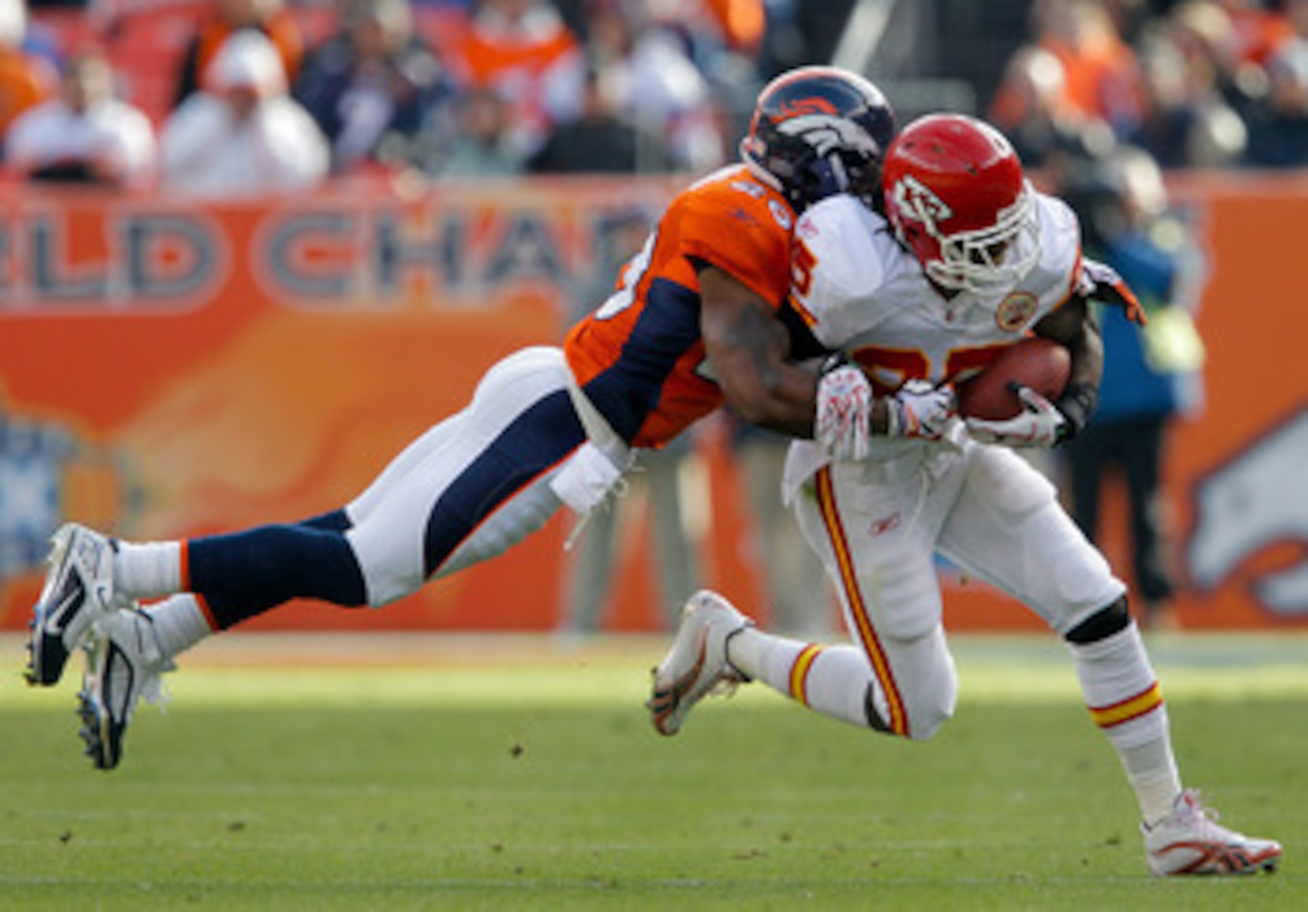 DENVER - NOVEMBER 14:  Safety Brian Dawkins #20 of the Denver Broncos makes a diving attempt to tackle running back Jamaal Charles #25 of the Kansas City Chiefs during the first quarter at INVESCO Field at Mile High on November 14, 2010 in Denver, Colorad